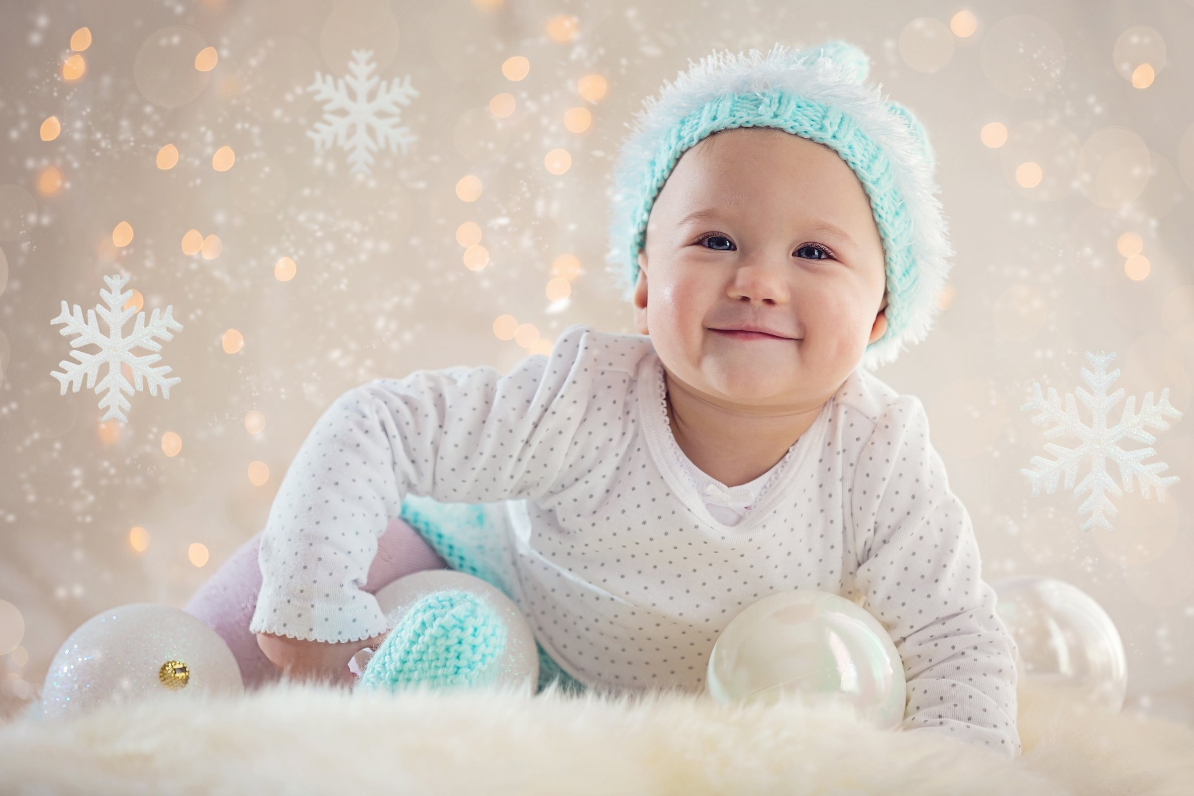 Portrait Of Cute Baby Girl Smiling On Rug Against Lens Flare