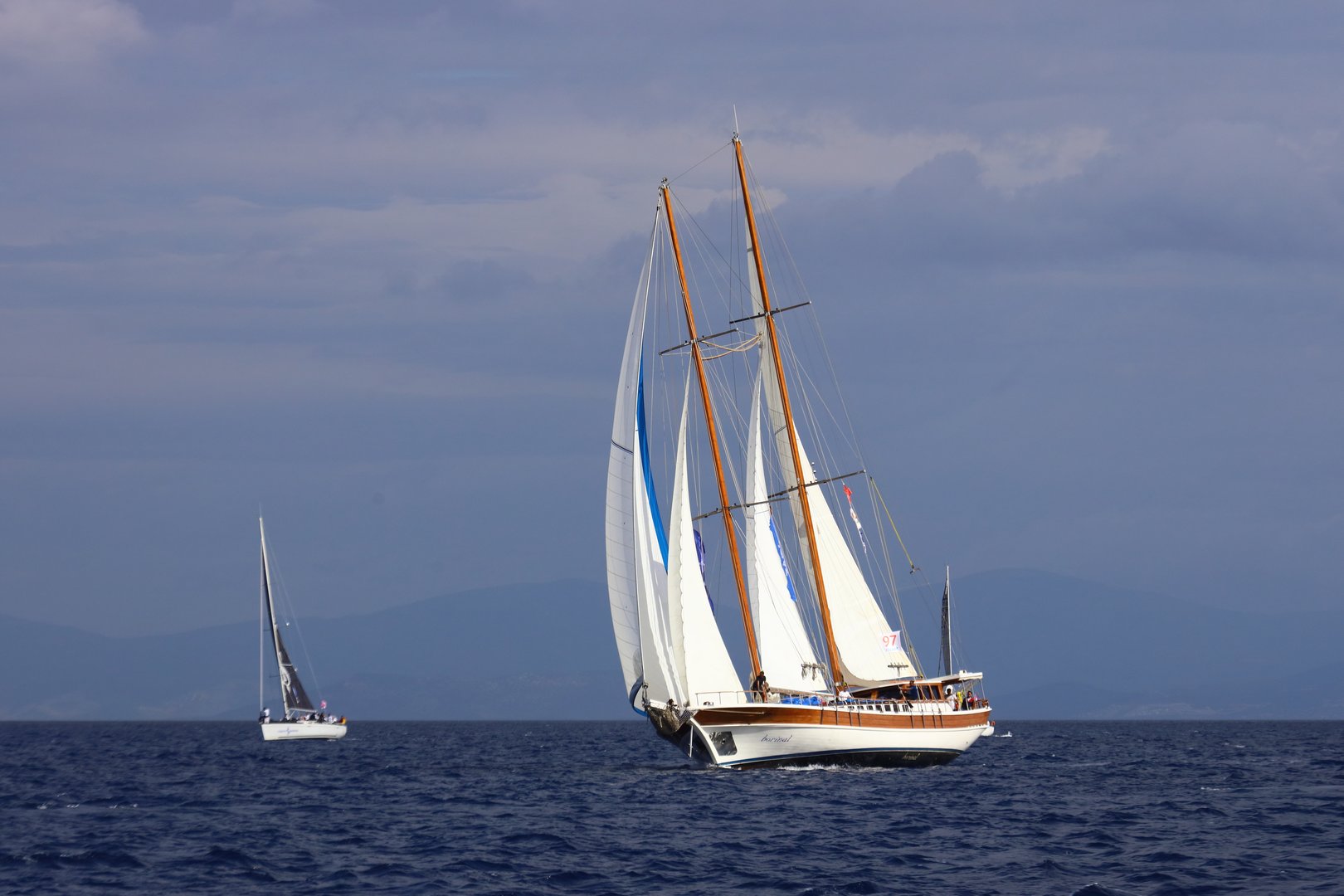 Bodrum, Mugla, turkey. October 24, 2025: Wooden sailing gulet boats cruise in the famous holiday resort of Bodrum during the autumn. Wooden boats with white sails sail in cloudy weather