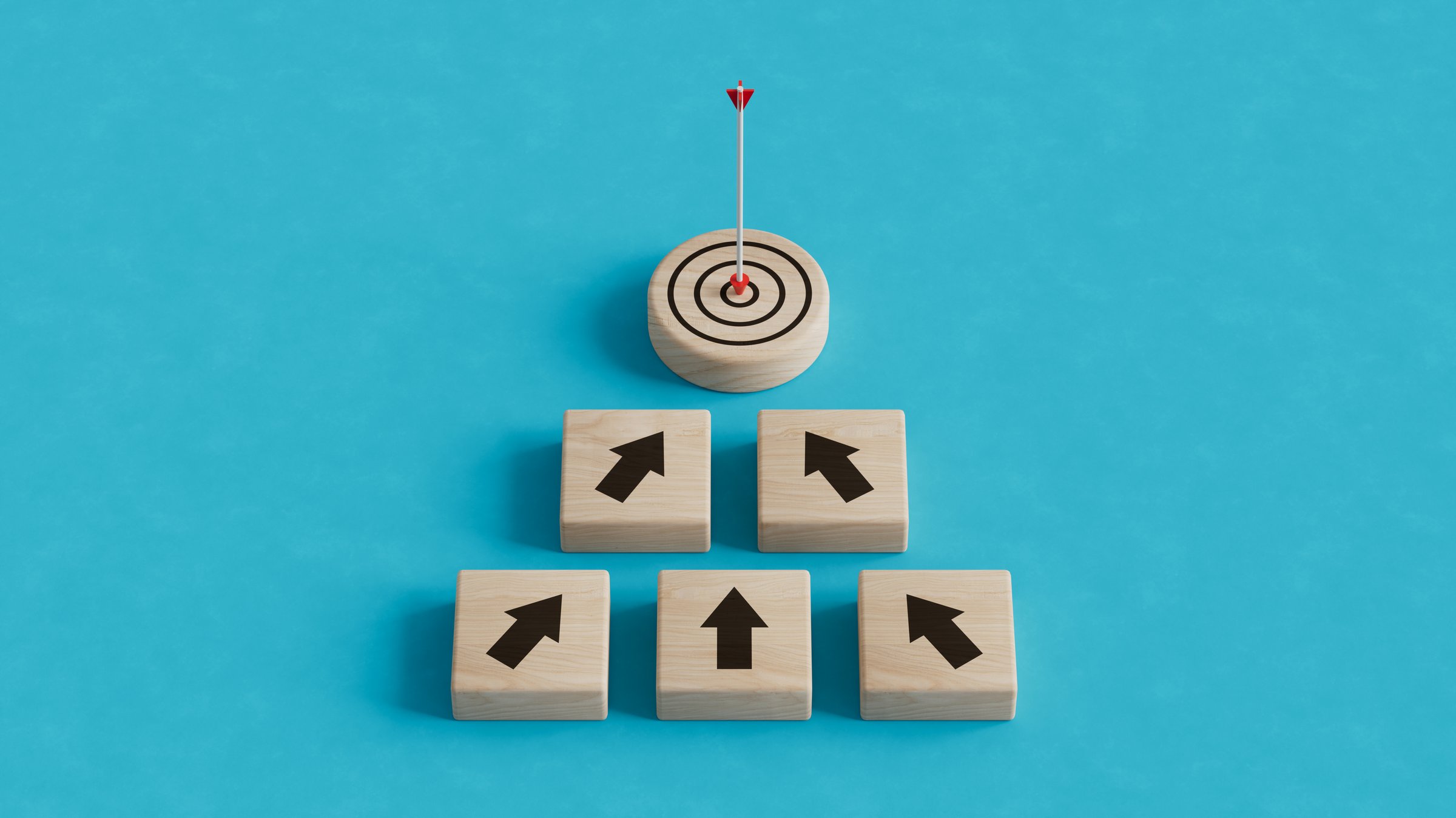 Financial goals concept with dart and target board wooden cube on up arrows. Target of investment and business concept.