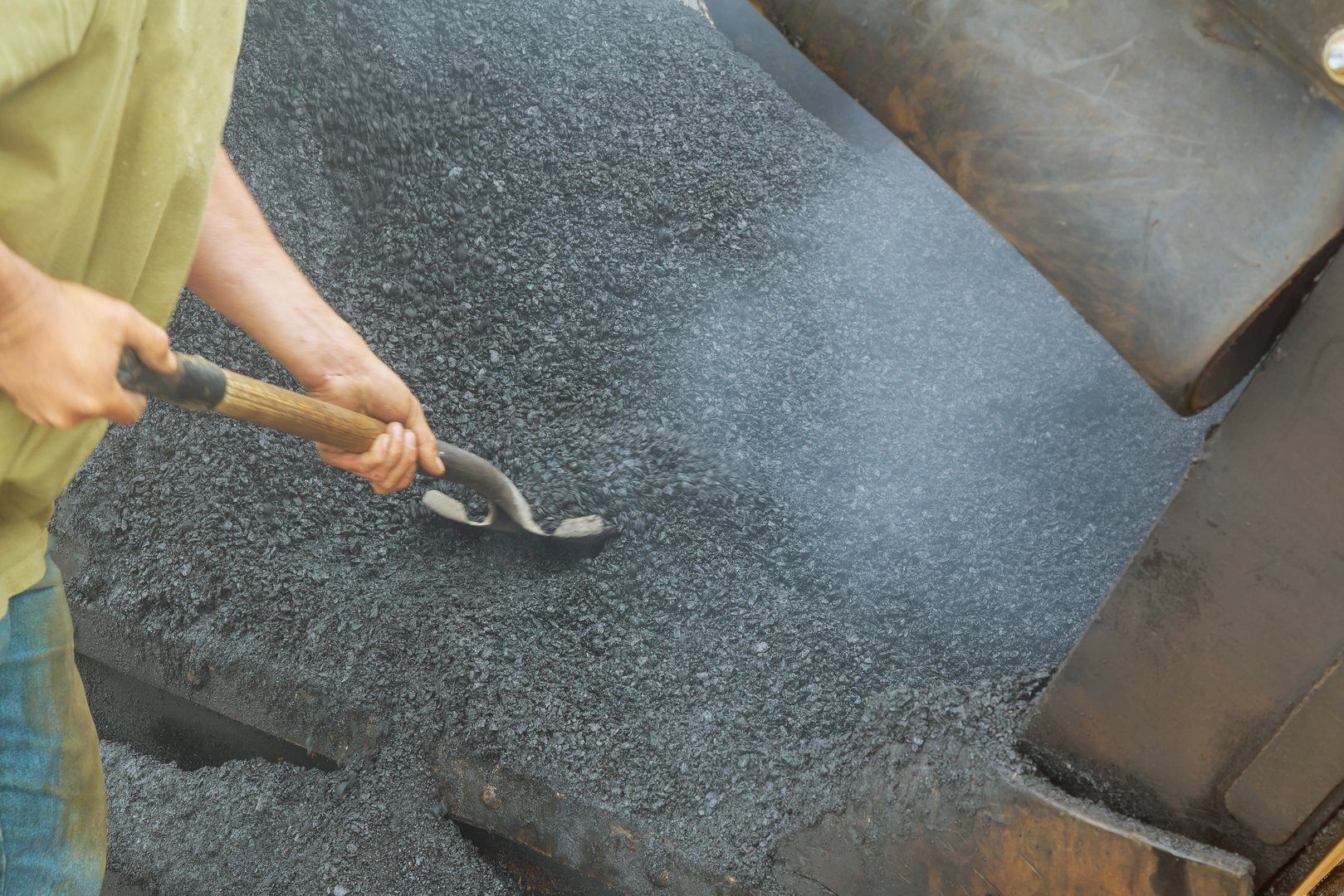 close-up details of industrial machinery working with asphal industrial laying fresh asphalt on construction site