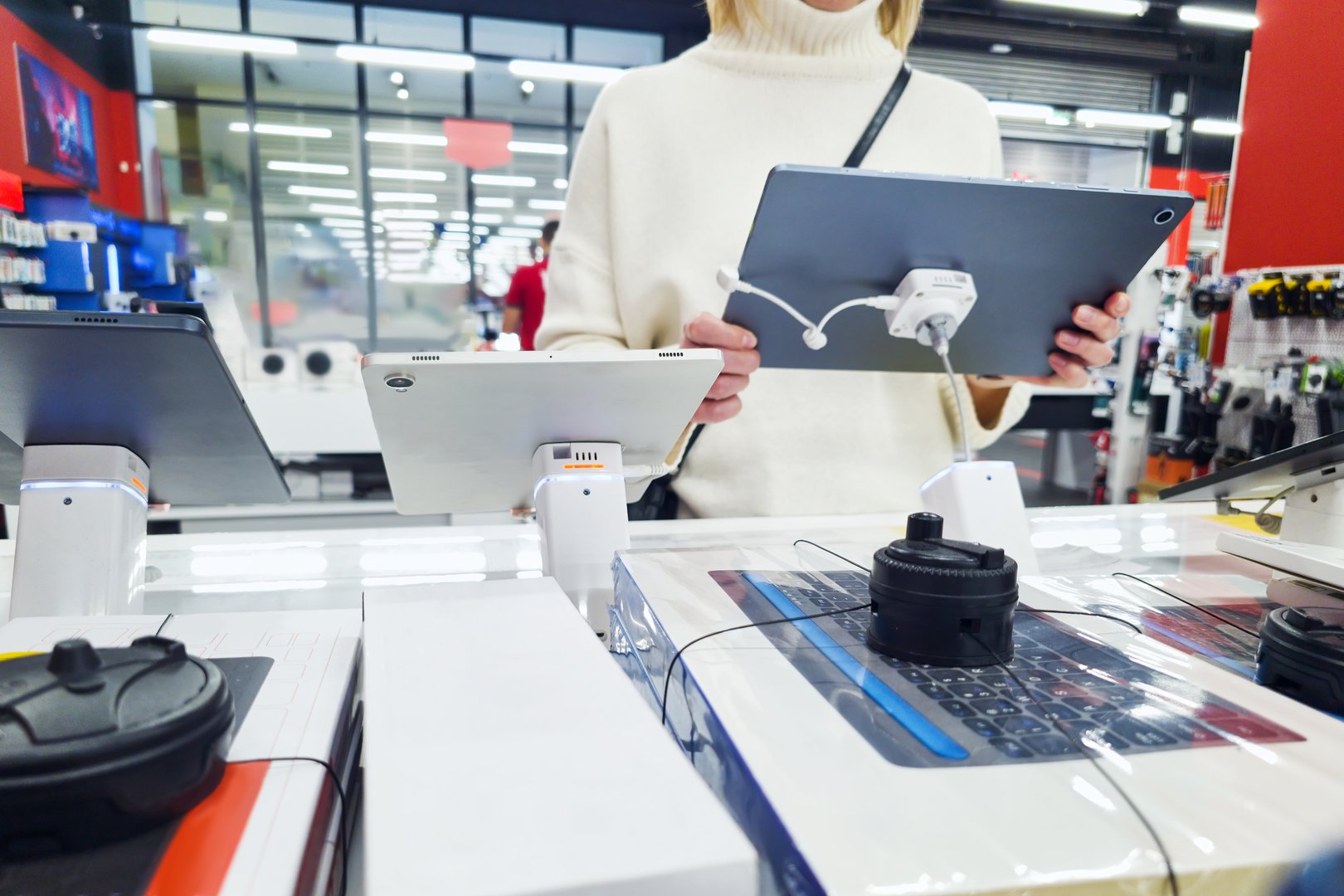 Woman customer with digital tablet in electronic store