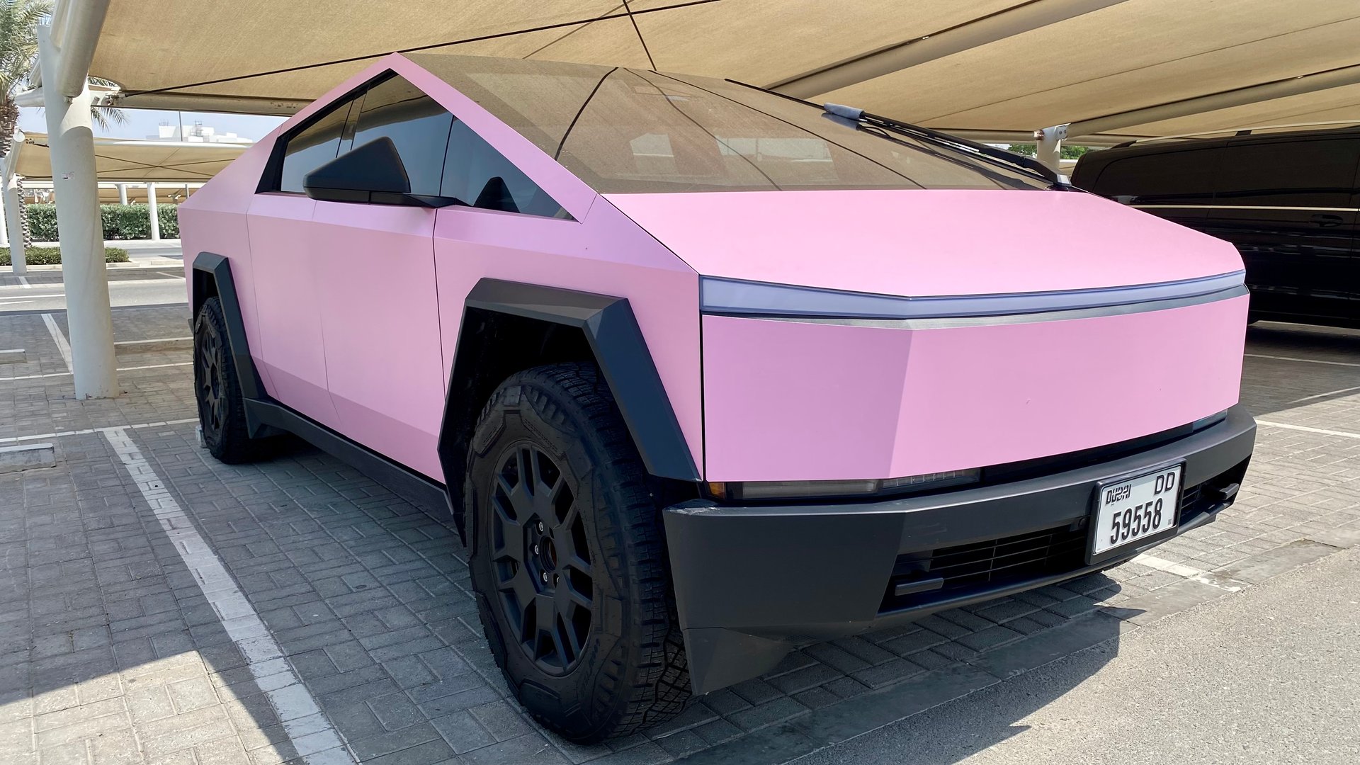Pink Color Cyber Tesla Truck in parked At Louvre Abu Dhabi, Abu Dhabi - United Arab Emirates 10 June 2025