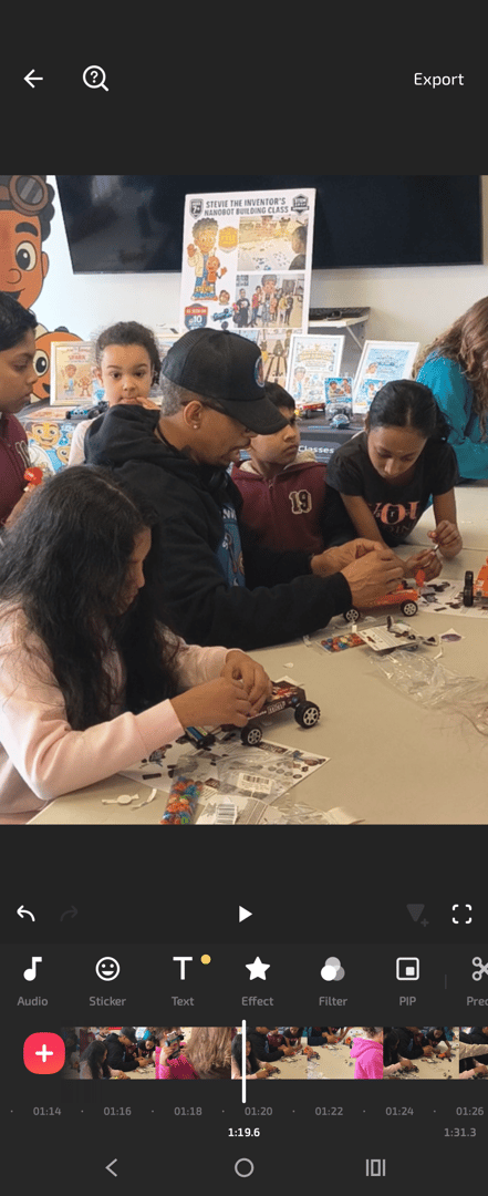 Student building robot with Stevie The Inventor