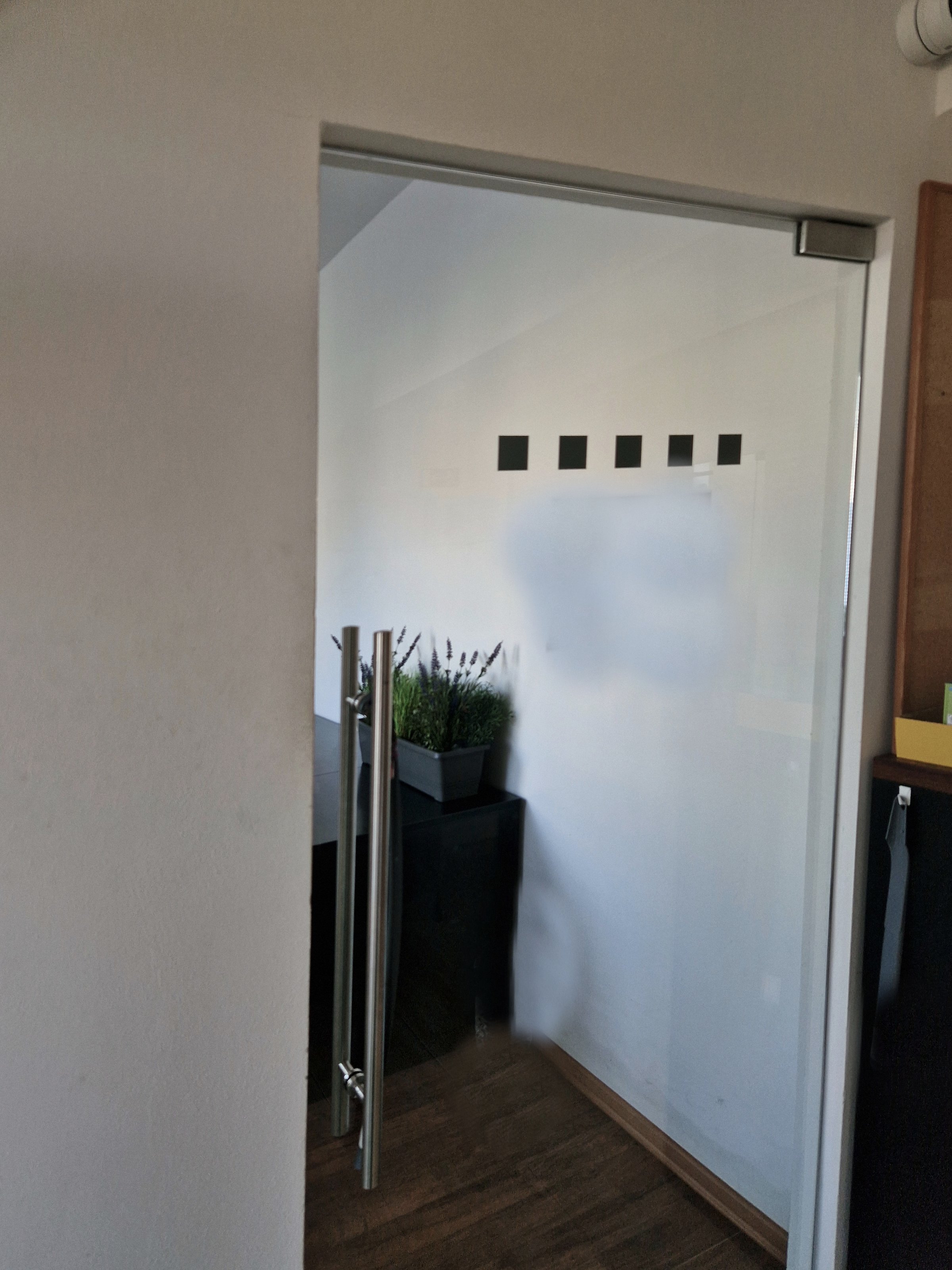 attic room with plasterboard ceiling is supported by pine wood beams. rustic style with a glass partition, light, frameless glass door. glazed partitions have special hinges, glassworks