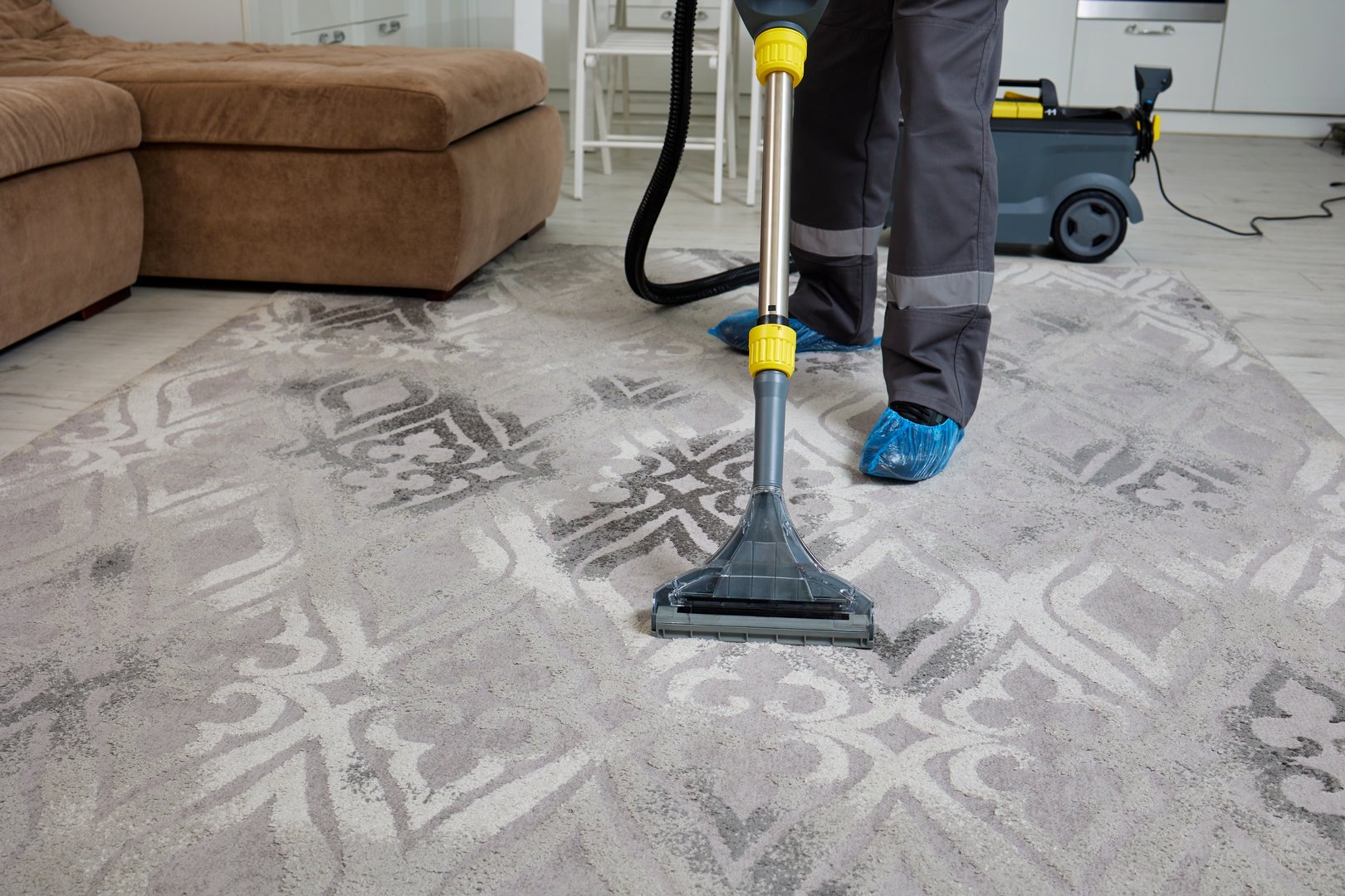 Professional cleaning service team working with cleaning equipment in room. Cleaning Service Concept.