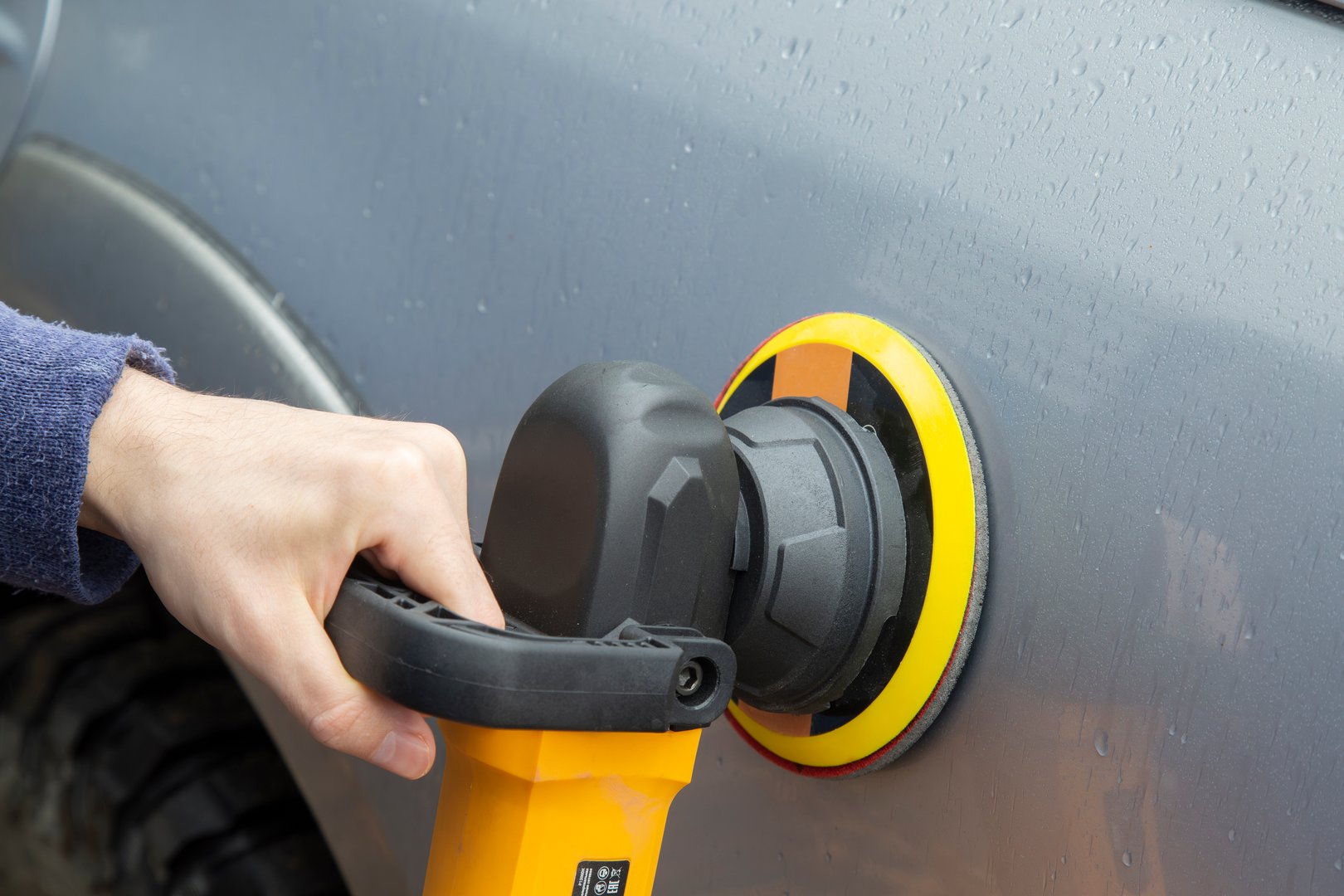 Polishing car body with grinder