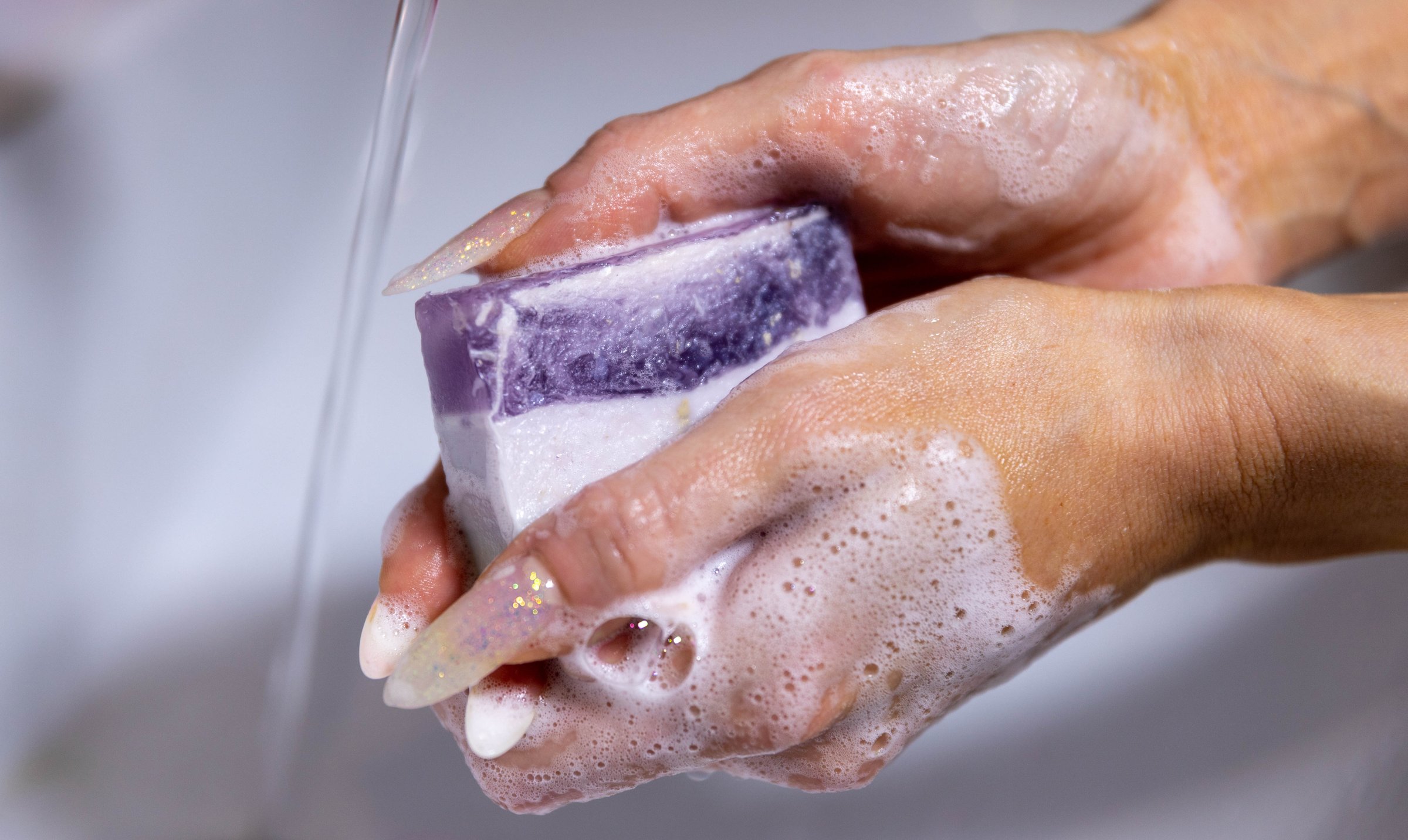 Woman is packing handmade natural soap as a gift for New Year and Christmas. Concept of preparing for holidays, hobbies, a cozy festive atmosphere.