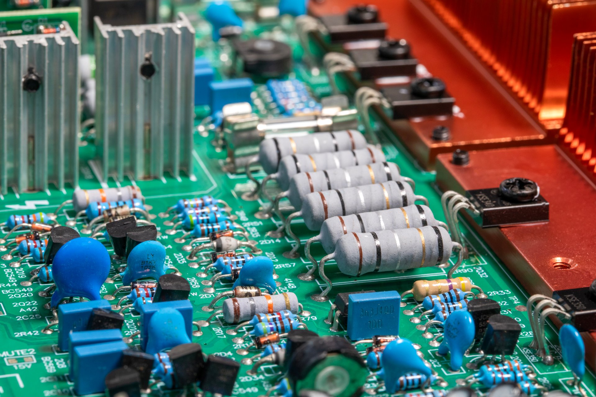 Electronic circuit board, transistors, resistors, capacitors, and diodes on the printed of an amplifier circuit board, close up
