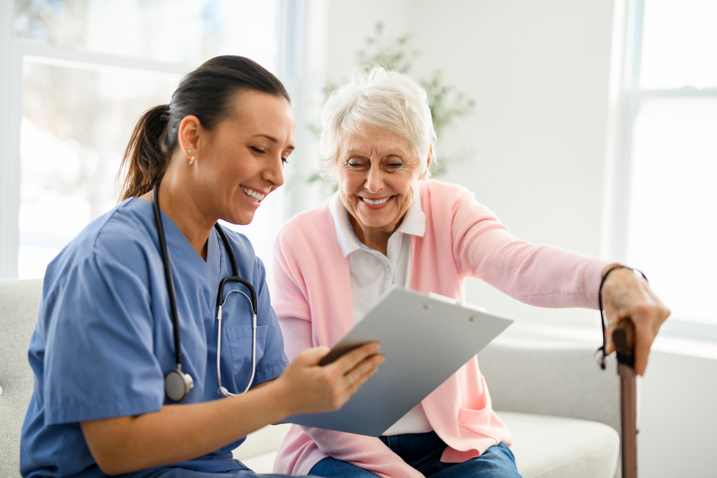 A portrait of a young nurse doctor with a senior patient at home during a consultation