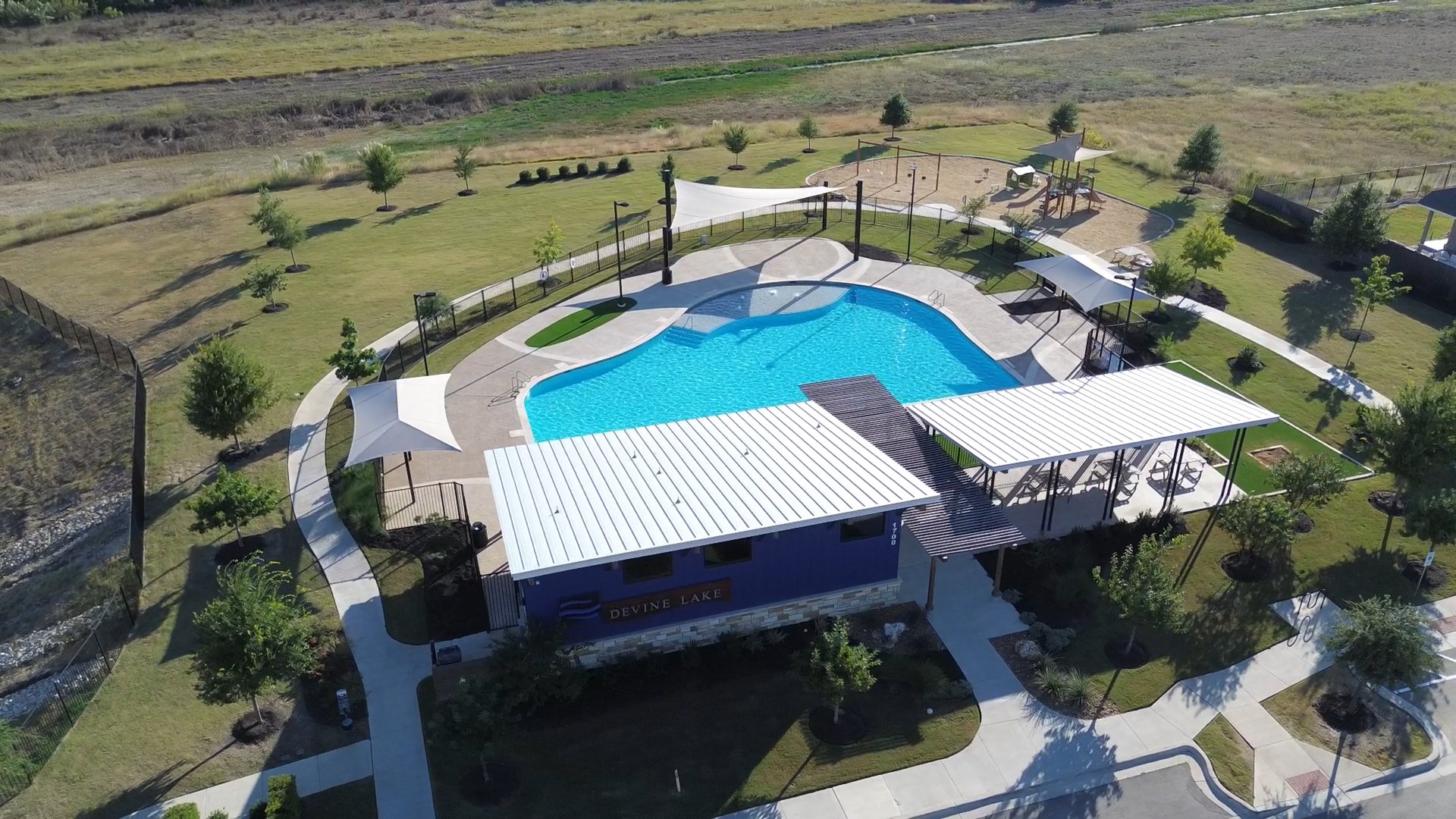 Aerial view of beautiful lake and pool property