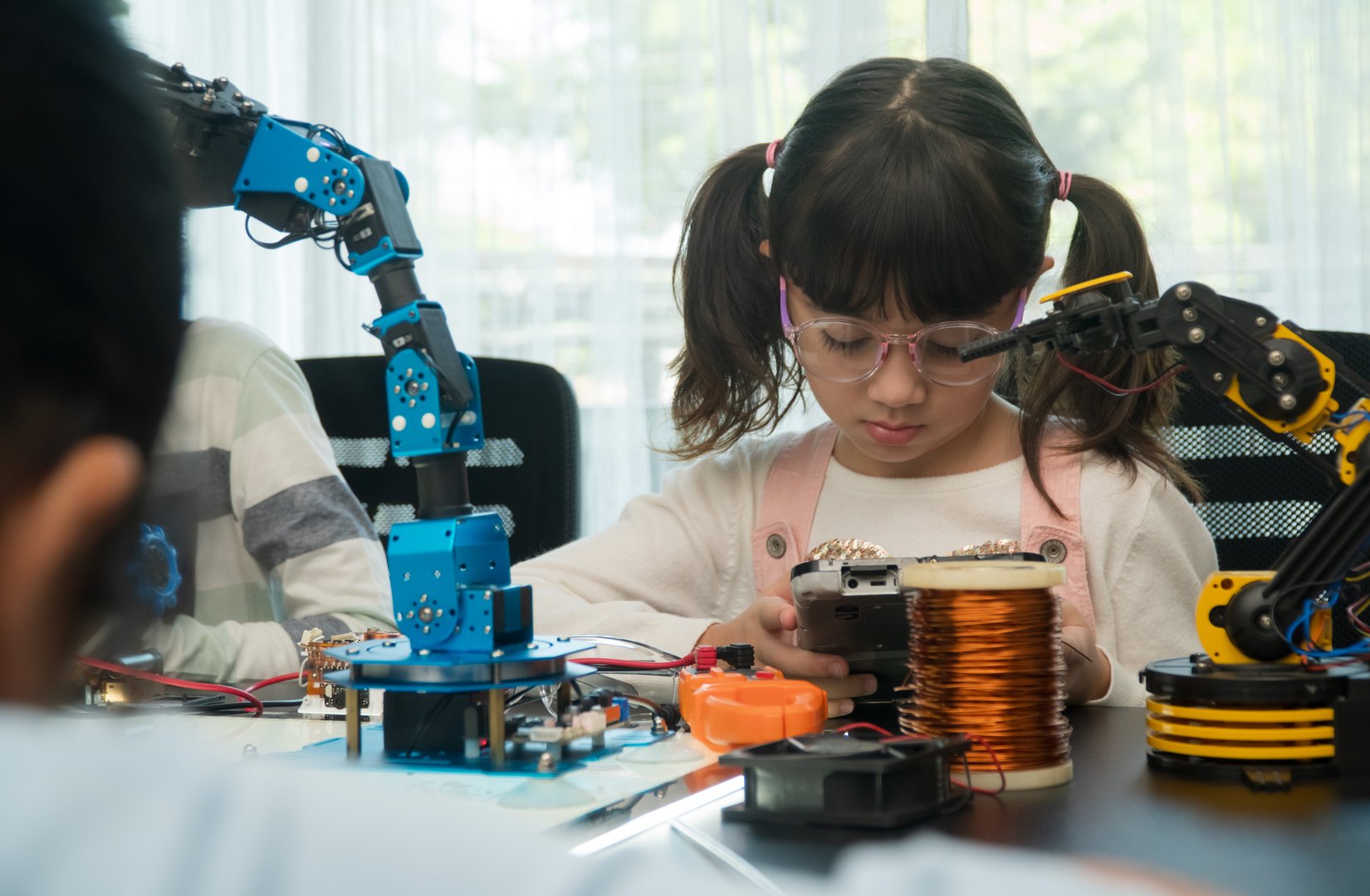 Education Topics : Group of school student boy and girl building and studying robot STEM programming software,technology of robotics programing and kids education concept.