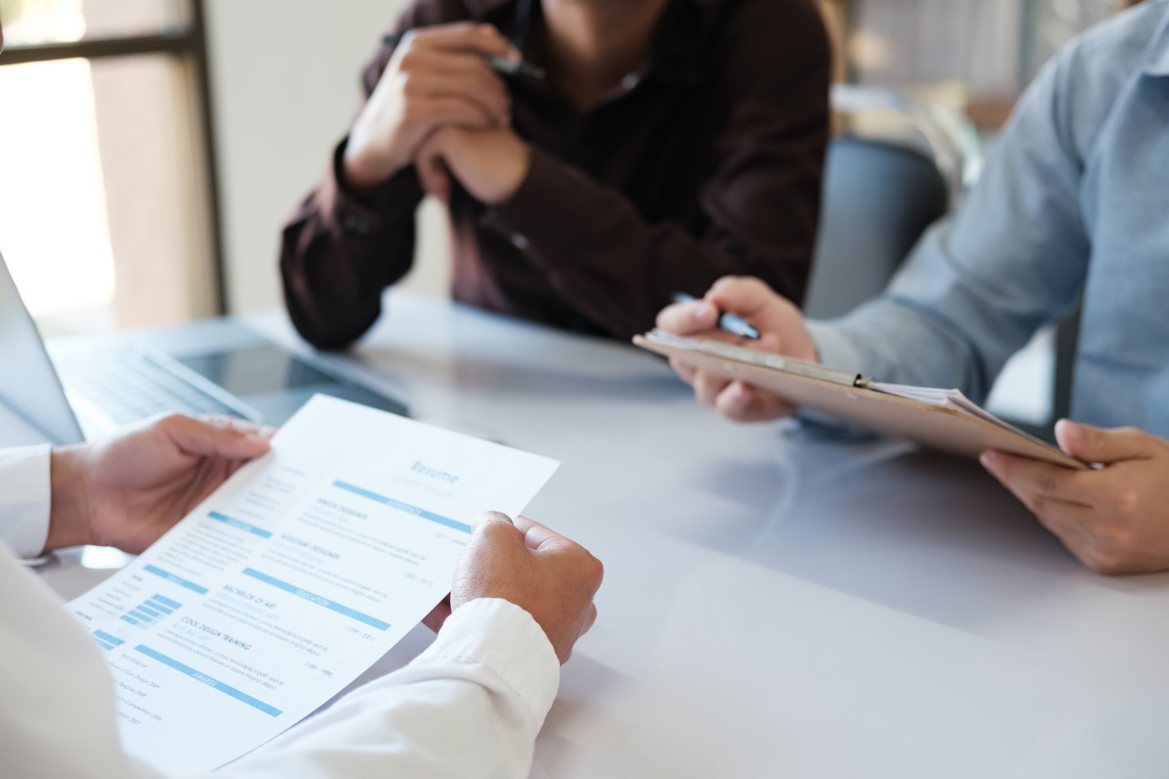 Managers and Human Resource department are interviewing job applicants. With the job applicant's resume. Business, employment, and recruiting people to work in appropriate positions