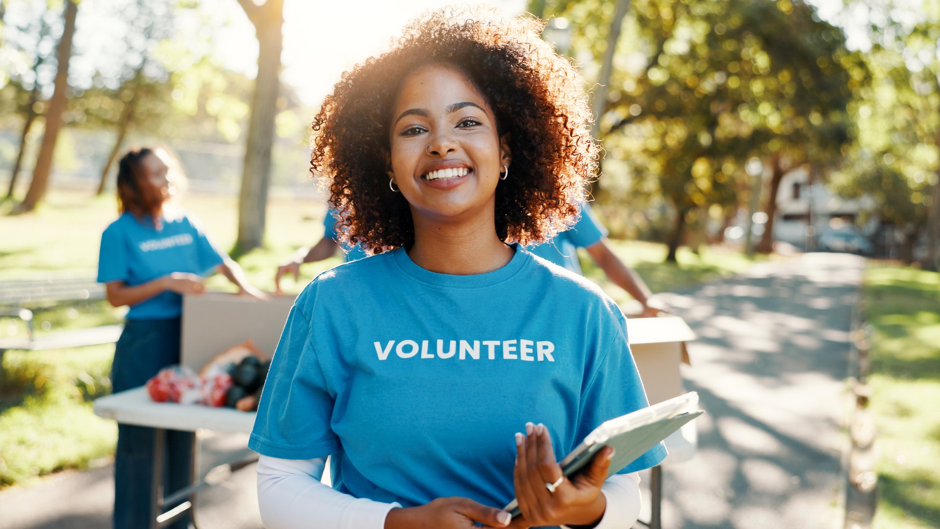Nature, woman and portrait of volunteer with tablet for checking food drive donation list. Confident, outdoor and female NGO worker with digital technology in park for nonprofit or charity event.