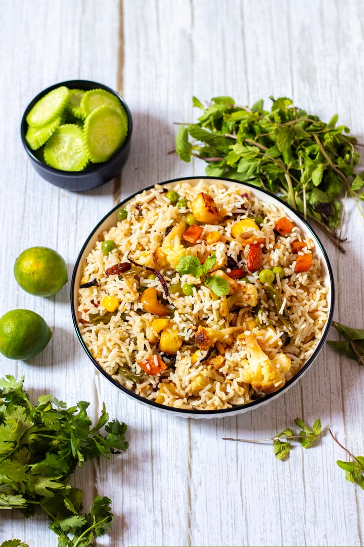 Navratan Pulao is a rich, aromatic Indian rice dish made with basmati rice, mixed vegetables, nuts, and dried fruits, offering a delightful sweet-savory flavor.