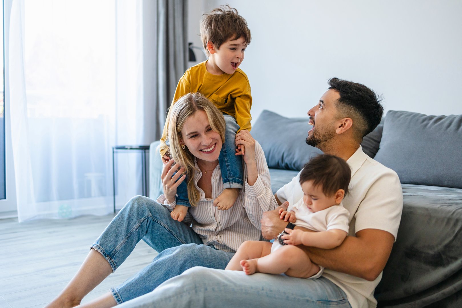 Happy young family playing together at home