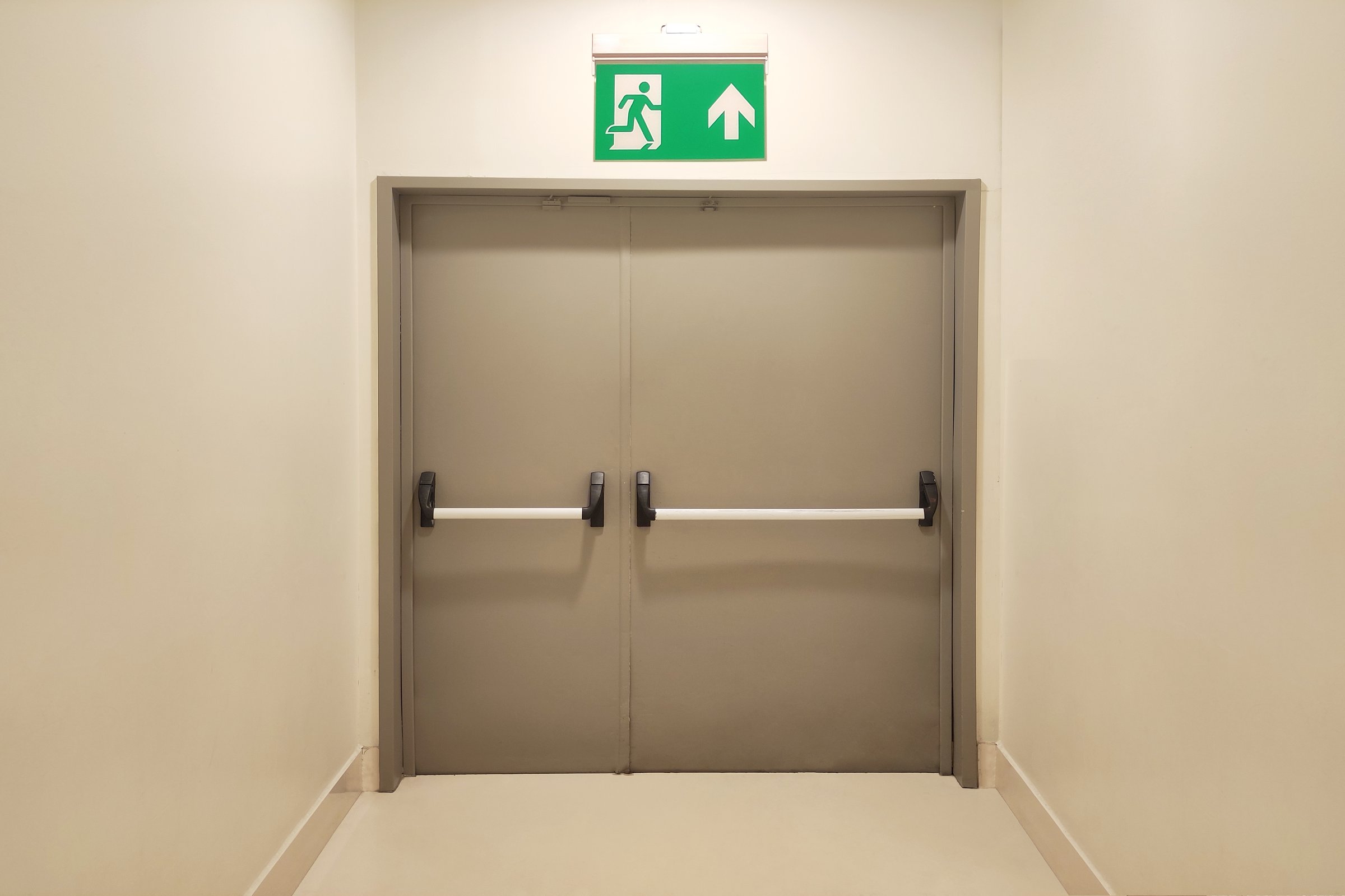 Emergency exit door at end of corridor