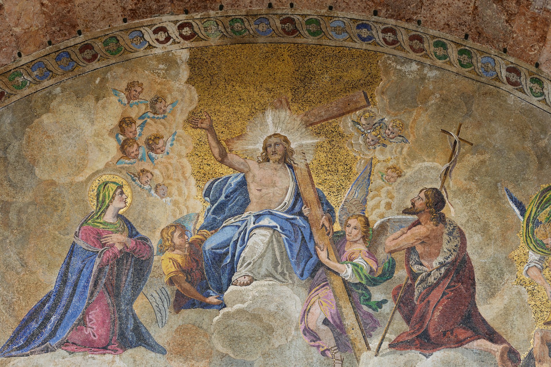 Detailed mosaic depicting Jesus Christ and saints surrounded by angels in Saint Mark Basilica in Venice Italy.