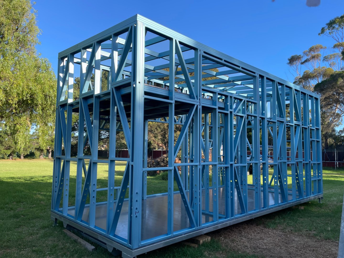 Modern prefabricated tiny house being built inside a spacious factory, showcasing the efficiency of modular construction