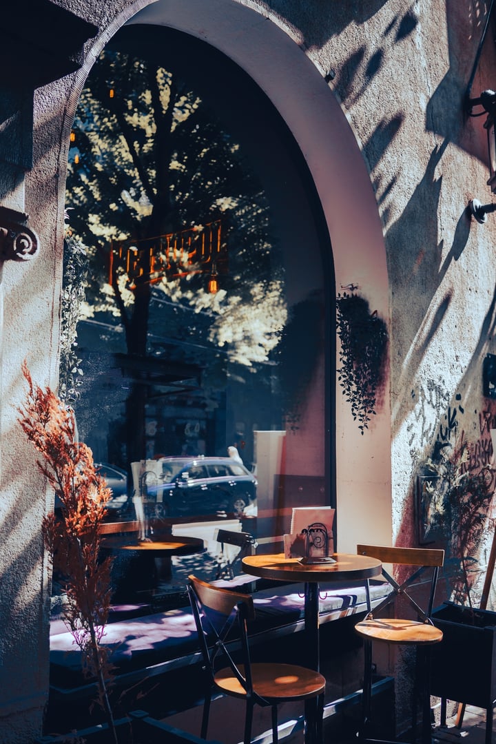 Chairs and a table in the garden of the restaurant in the morning sun.