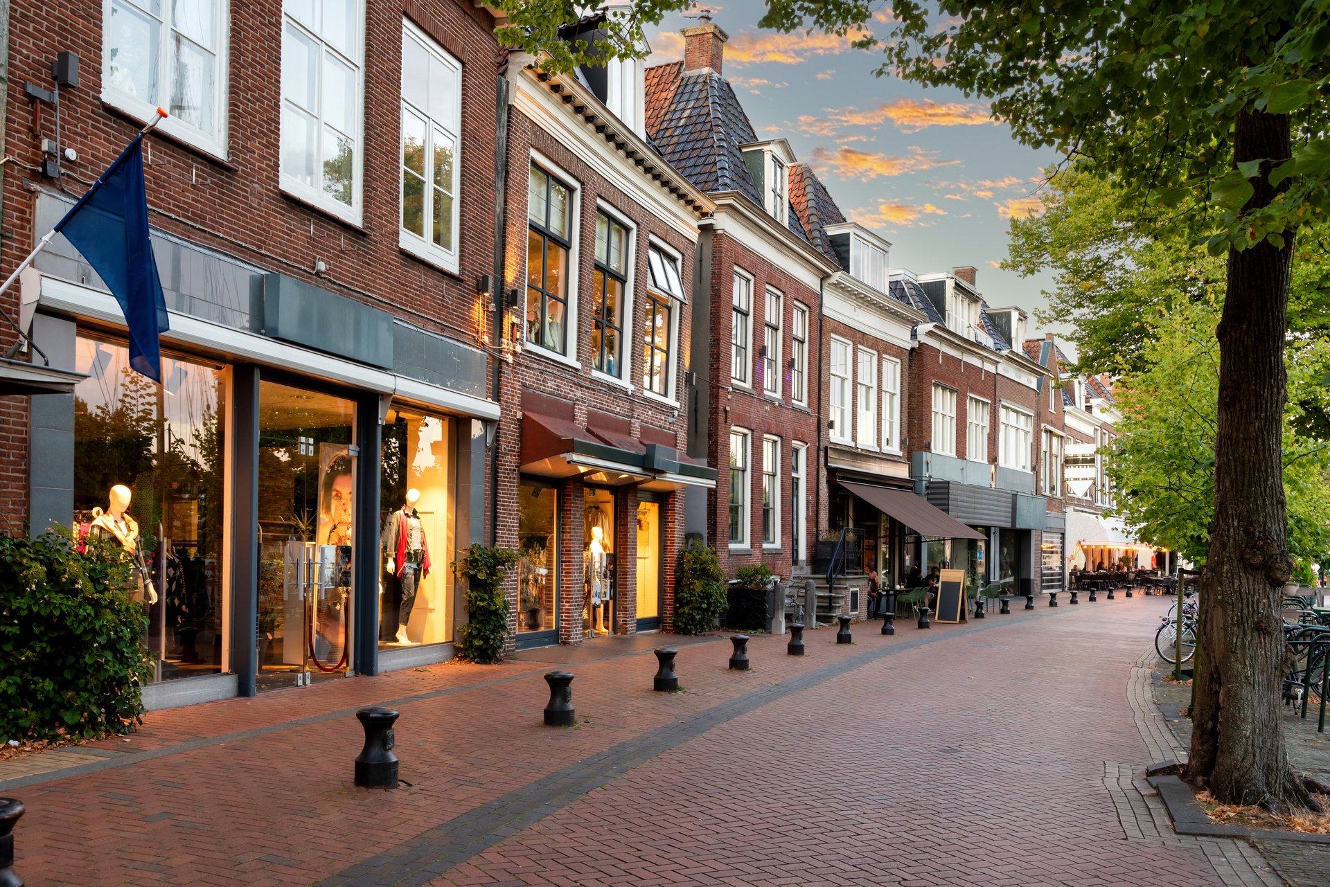 Small shopping street with restaurants in Diepswal street at evening, Dokkum, Netherlands
