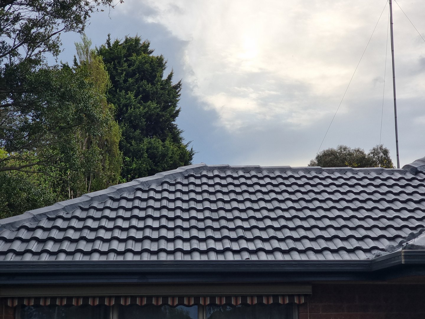 Quality Painting Group roof project from September 2024 showing professional tile roof restoration and coating work