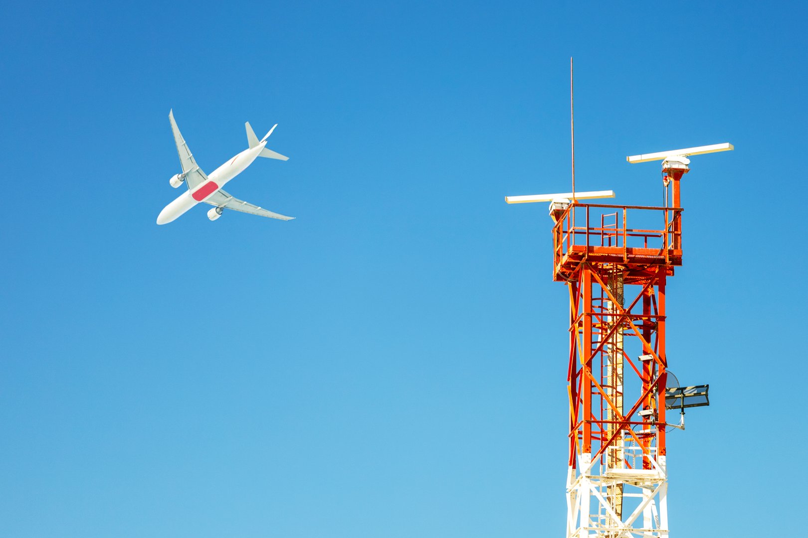 Airport radar and flying airplane on blue sky background. Air traffic control concept.