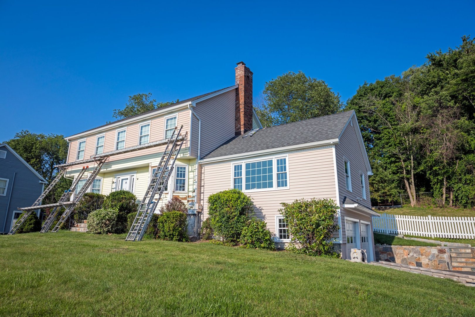 Monroe, Connecticut, USA: July 18th 2017; High resolution image of a colonial style house being painted