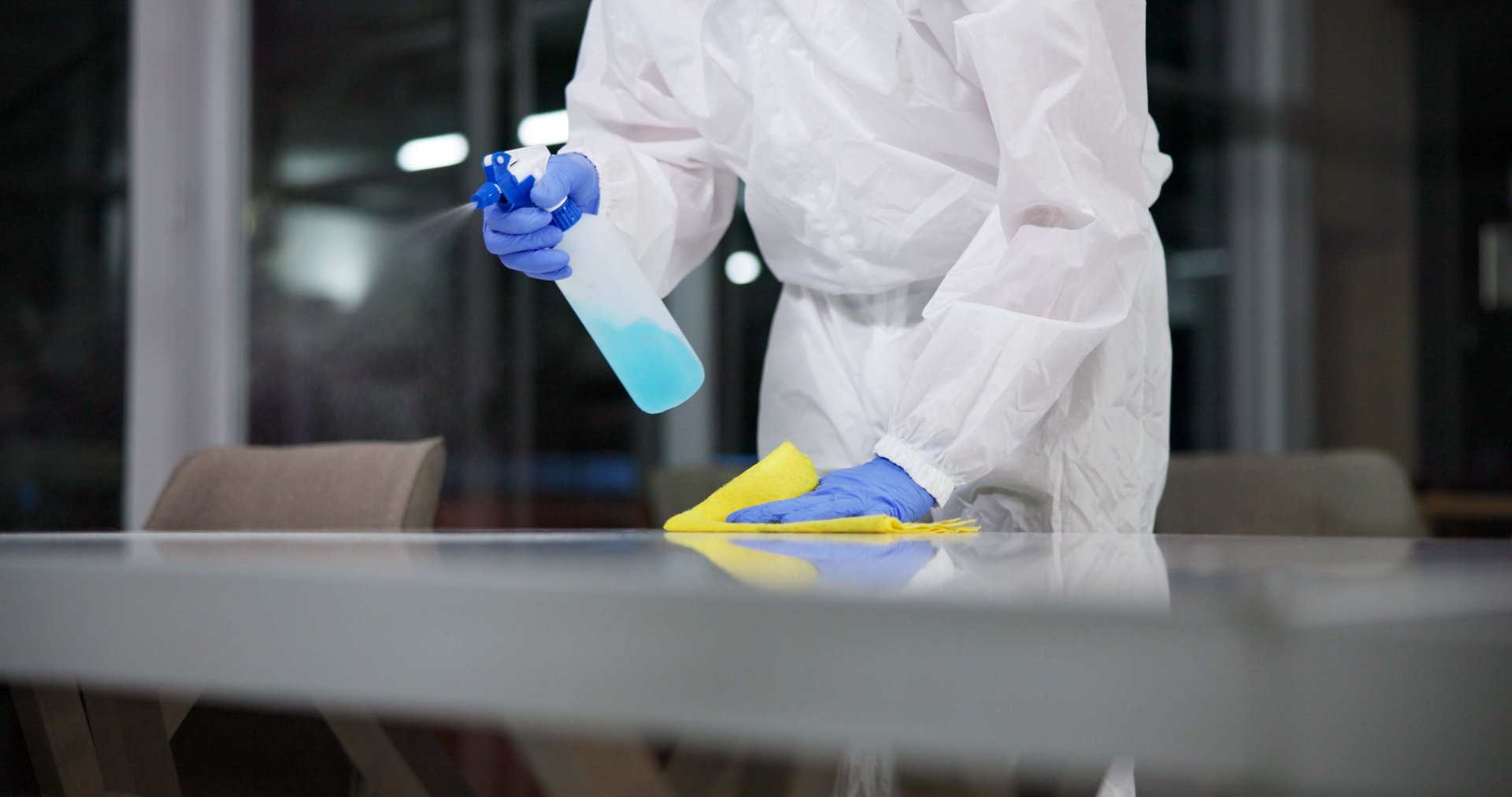 Cleaner, cleaning table and person in office for fumigation, spray disinfect and safety suit from disease risk in building