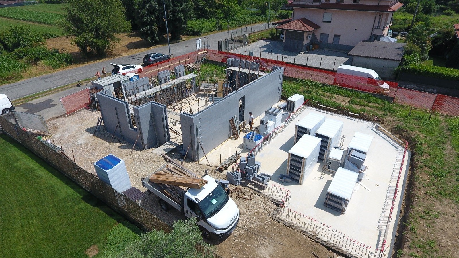 Professional construction team discussing renovation plans with blueprints and tablets on a construction site