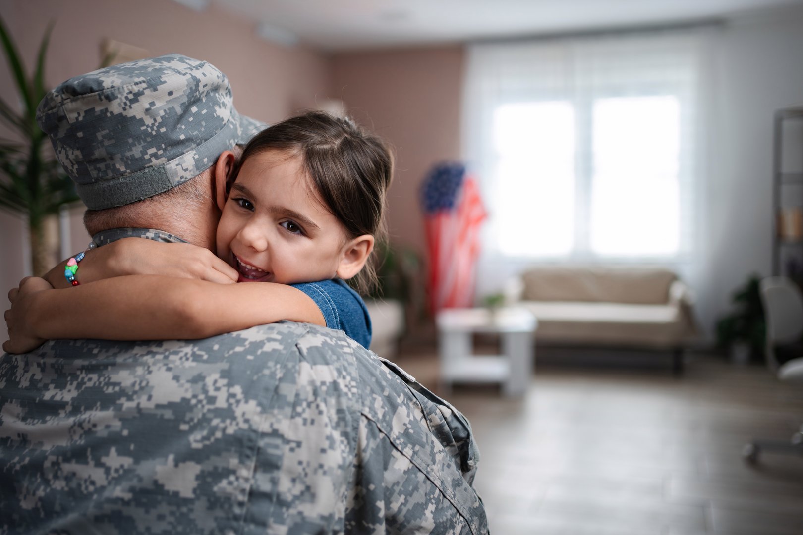 Soldier hugging daughter after returning home