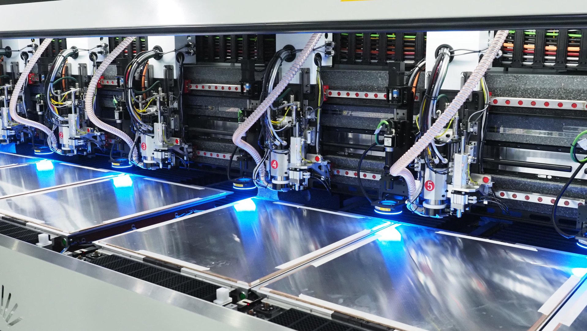 High tech automated CNC machine processing metal sheets with precision, used in industrial manufacturing.