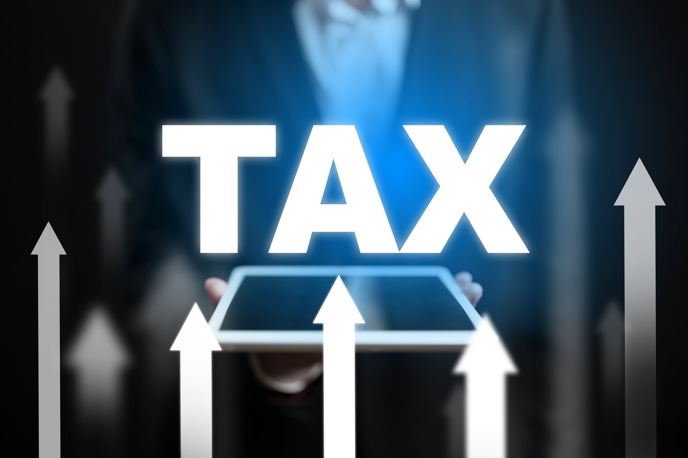 Business professionals analyze tax implications for enhancing economic growth strategies.