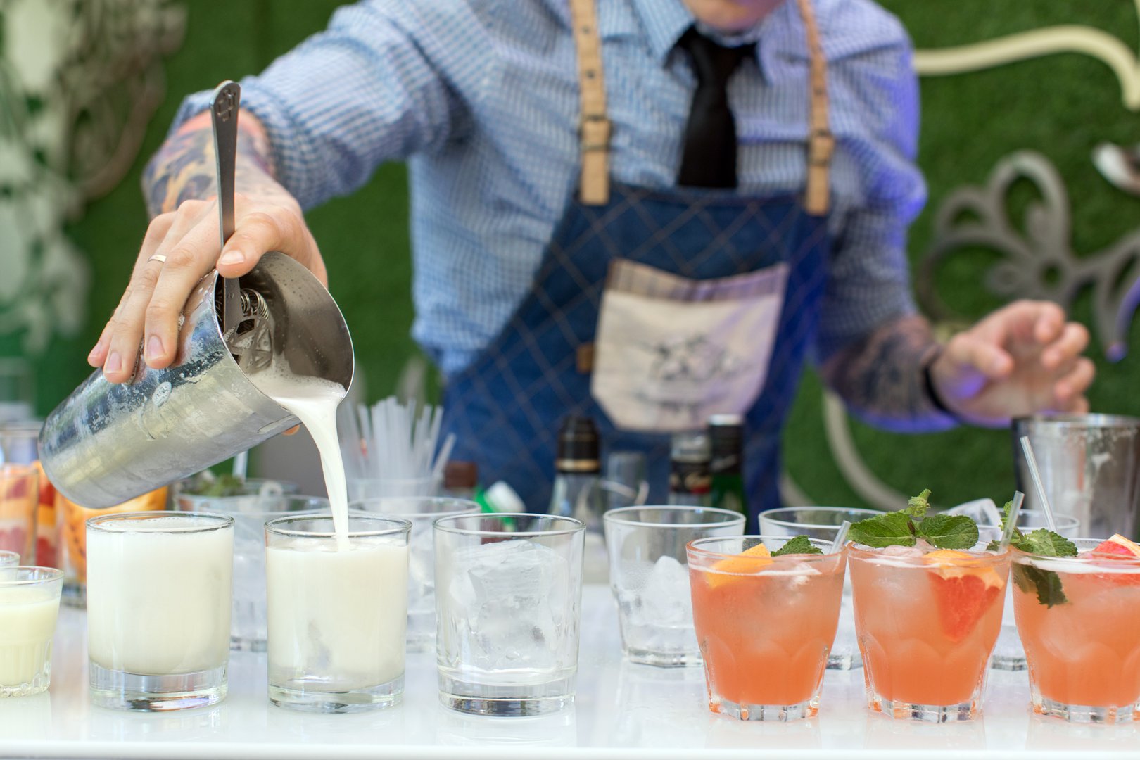 Professional bartender pouring cocktails at corporate function
