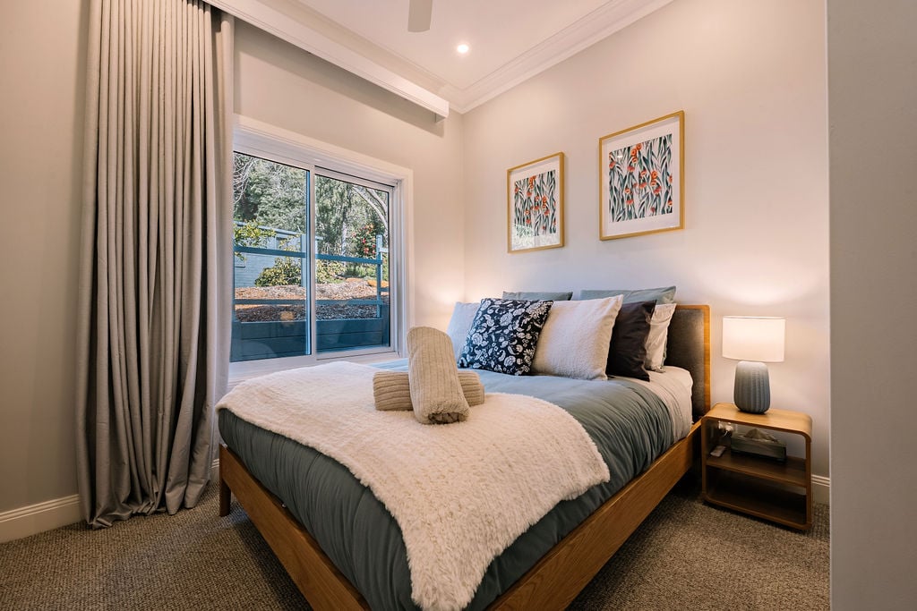Beautiful bedroom at Woodlands Cottage with luxury linens and bedside lamp