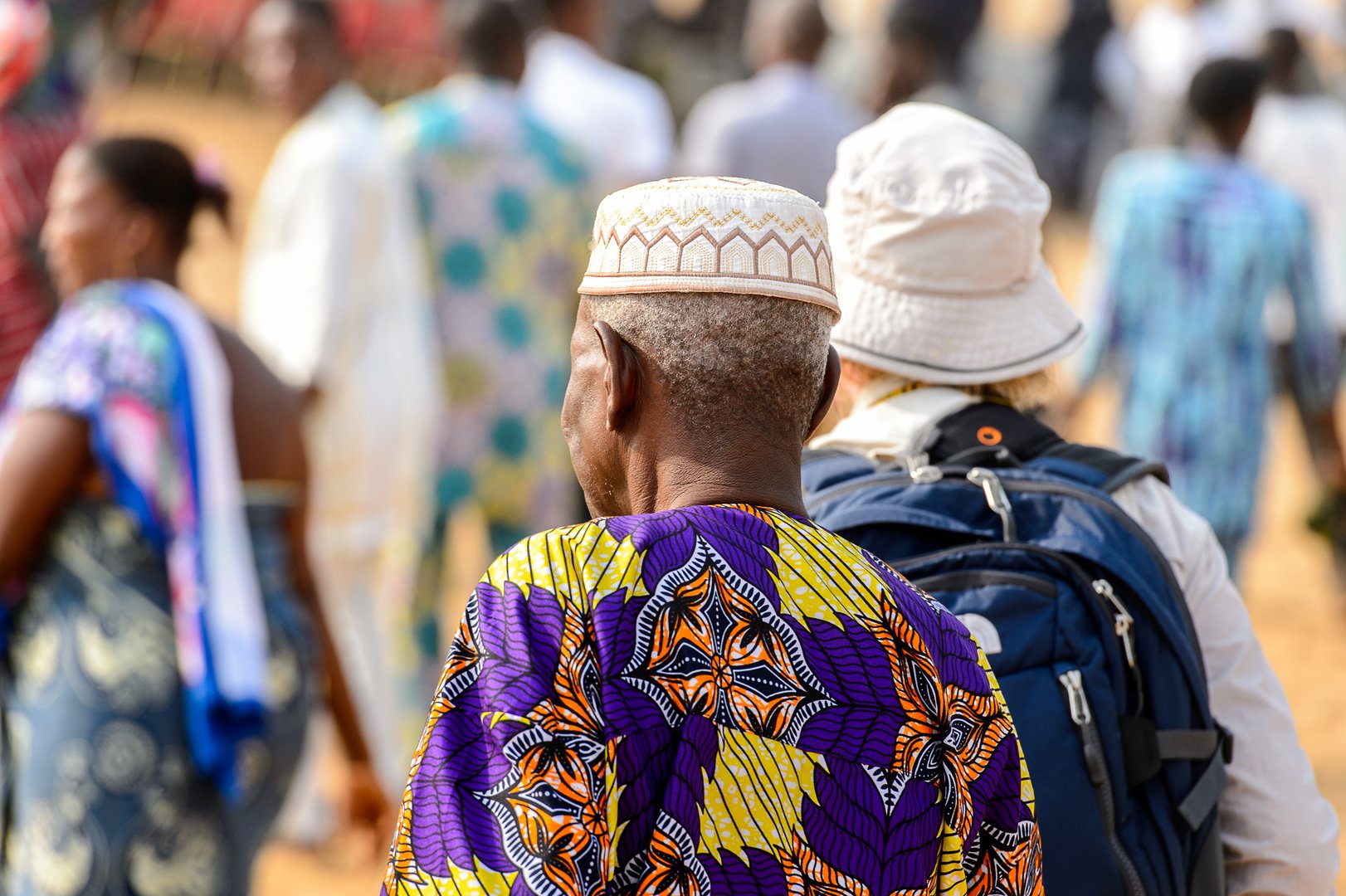 OUIDAH, BENIN - Jan 10, 2017: Unidentified Beninese  old man in national suit from behind at the voodoo festival, which is anually celebrated on January, 10th.