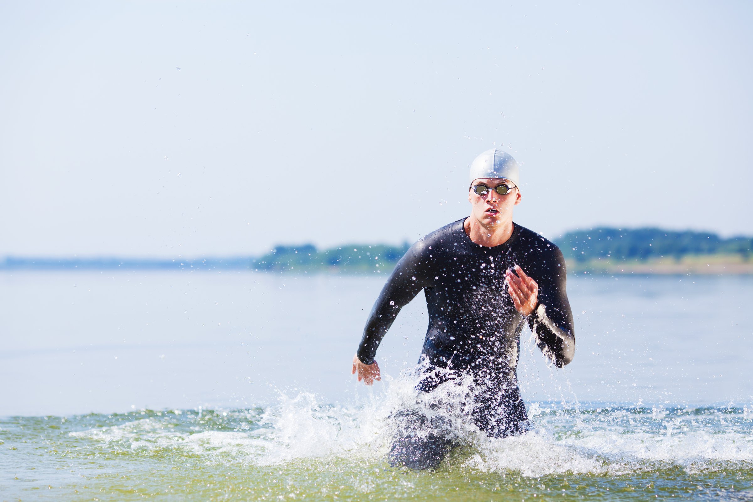 Sugarfree.space Iron Man triathlete emerging from water in California, showcasing peak athletic performance and endurance nutrition excellence