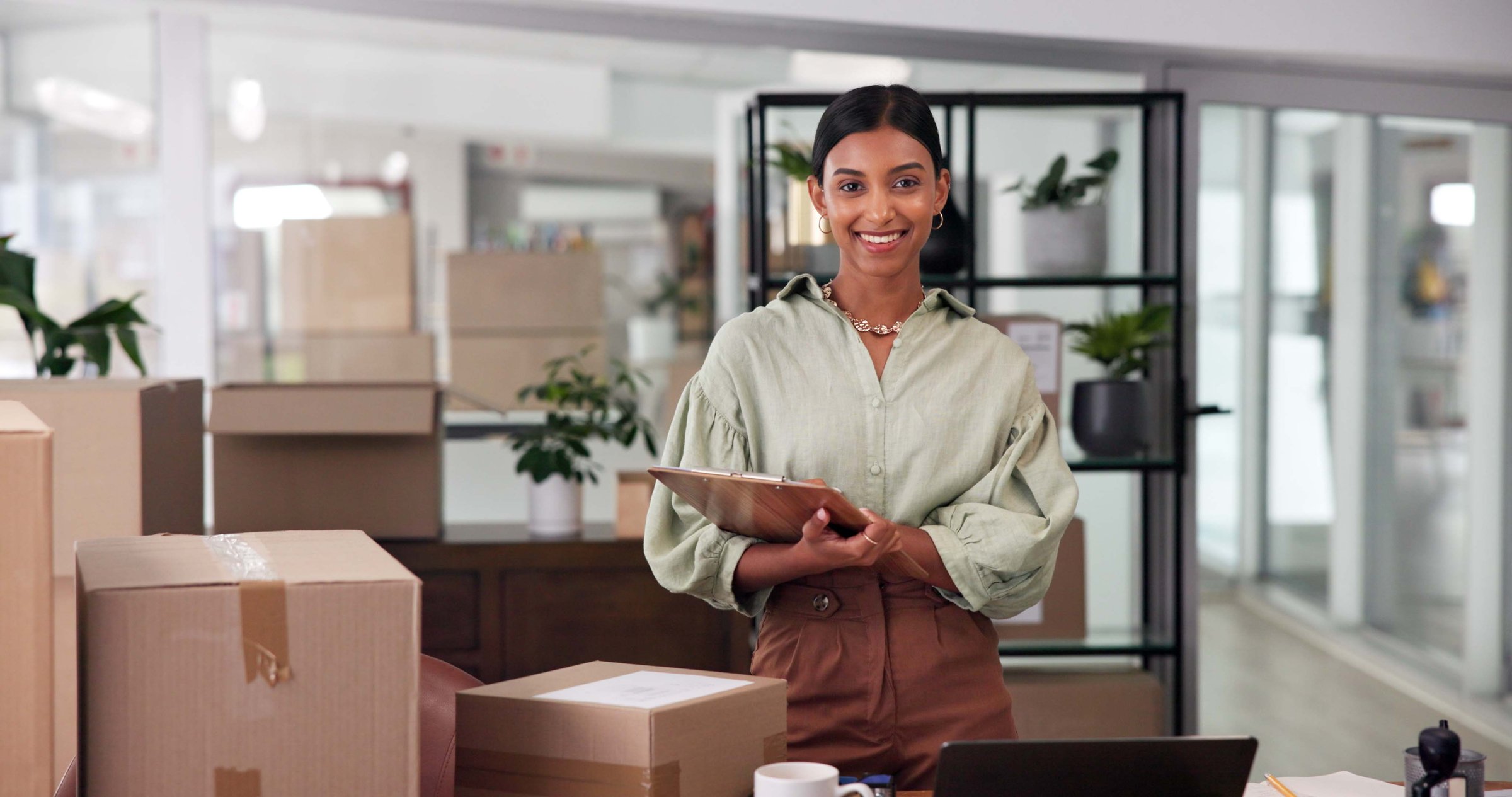 Portrait, boxes and woman with clipboard, inventory and ecommerce with startup, smile and supply chain. Face, happy person and seller with documents, checklist for stock and cardboard with industry