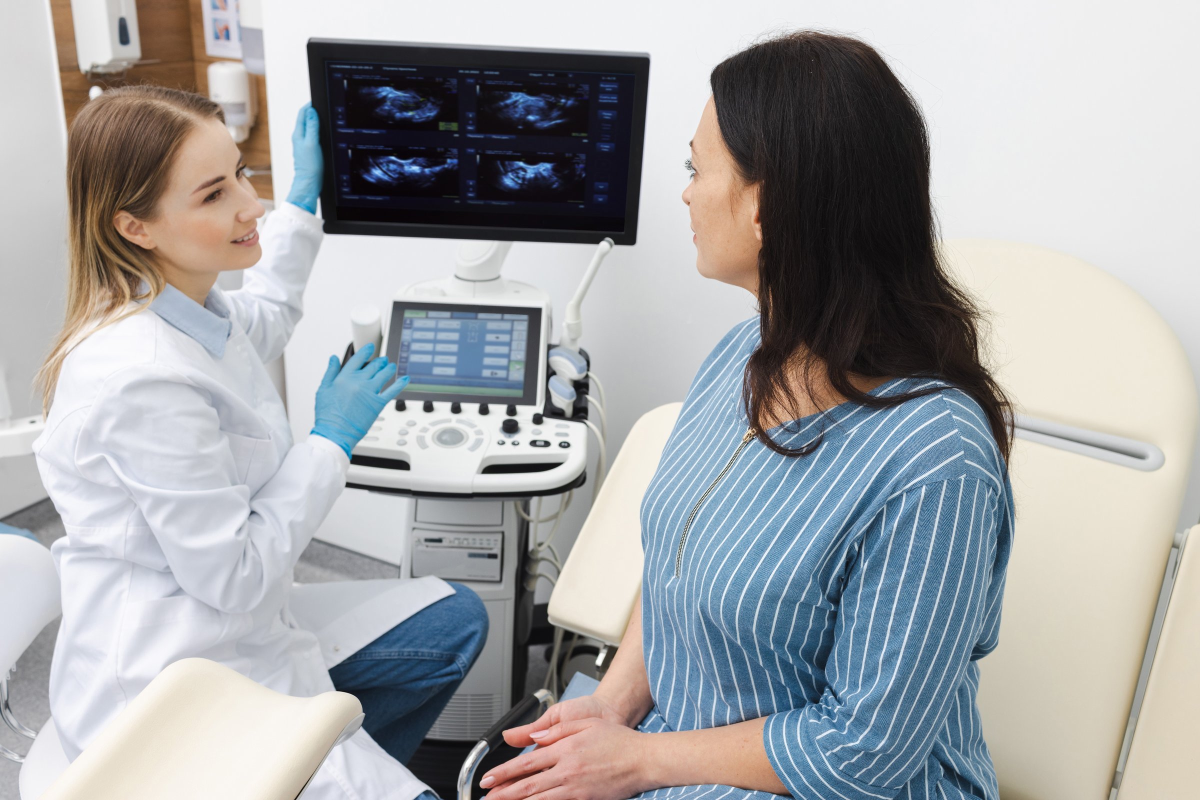 Woman having an ultrasound examination of uterus and ovaries at the gynecologist office in a modern clinic. Women's health