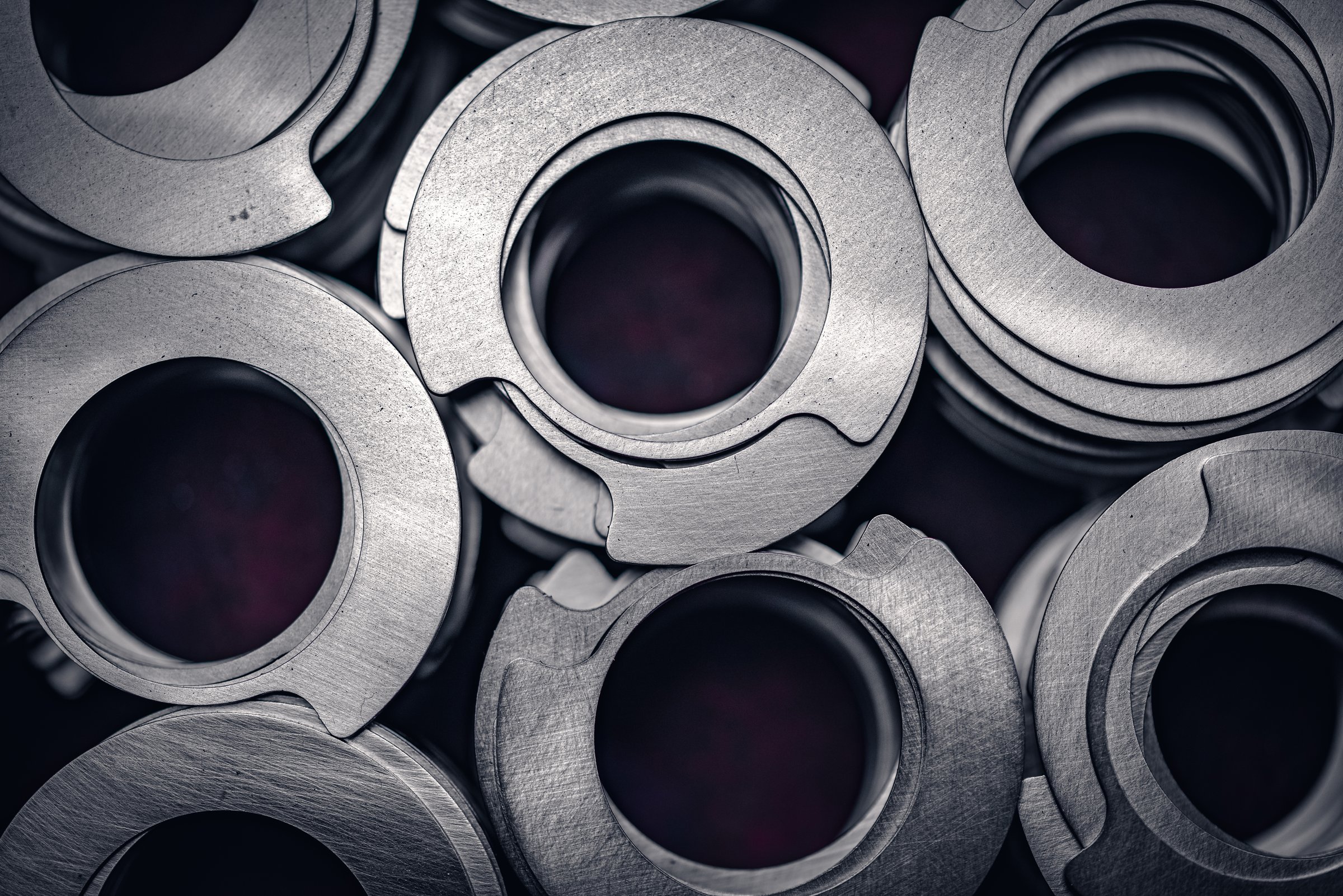 Close up of small metal gears and parts stacked up after production