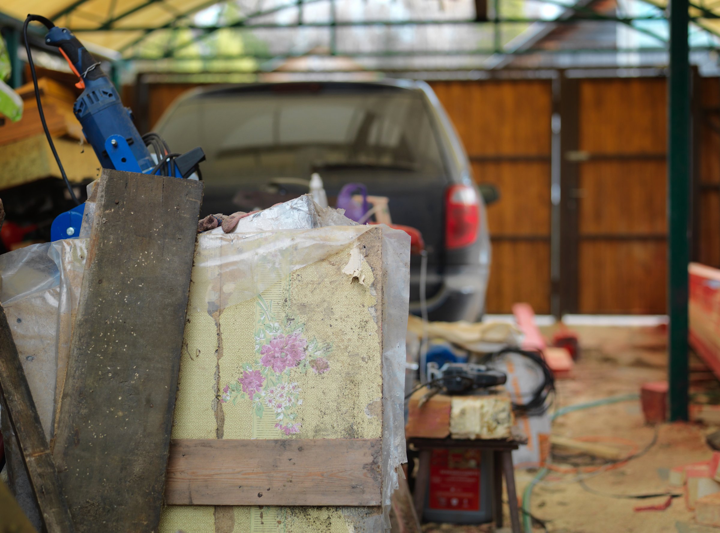 a garage or yard refurbishment and a stack of unwanted stuff in the foreground