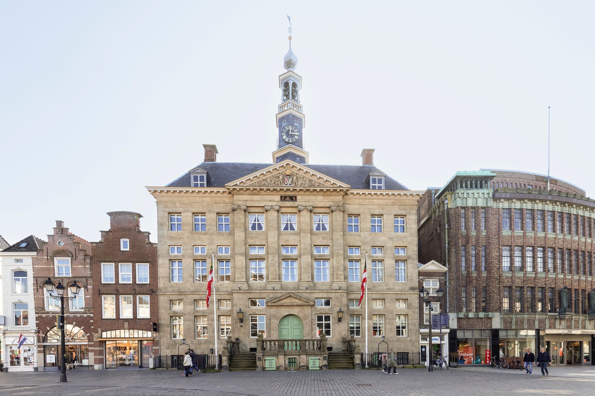 Den Bosch, Netherlands, February 23, 2025; People walk through the pleasant center of Den Bosch with the 14th century town hall in the background.