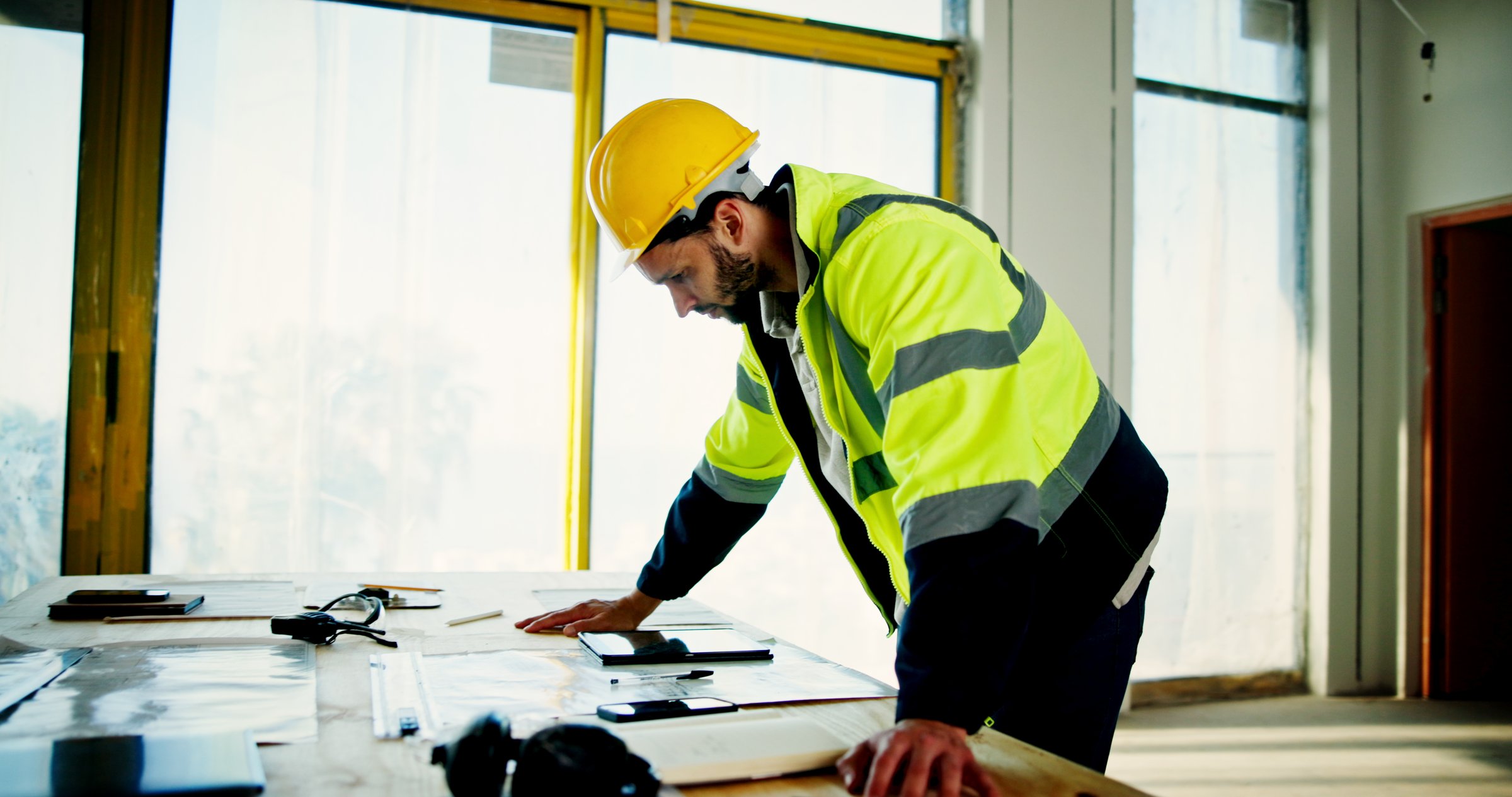 Architecture, planning and blueprint with man on construction site for building, real estate and inspection. Engineer, industrial and property developer with person for contractor and renovation