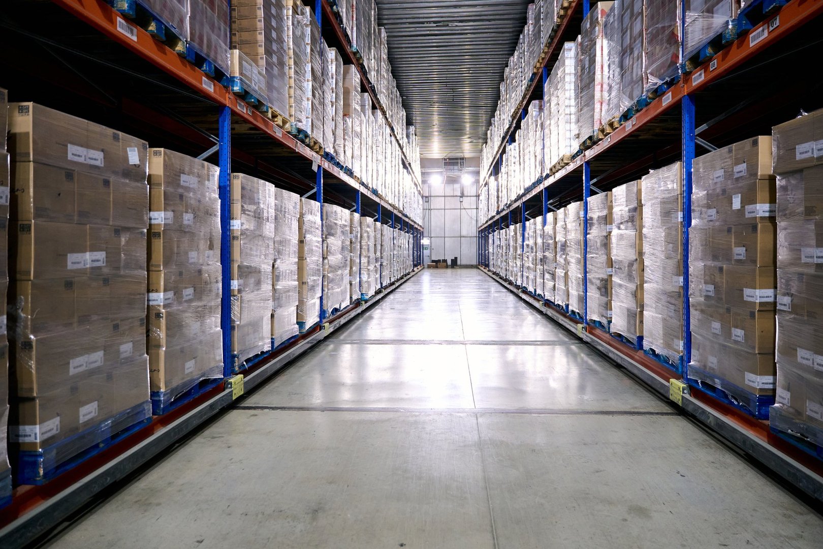 Warehouse interior with rows of pallets holding boxed goods