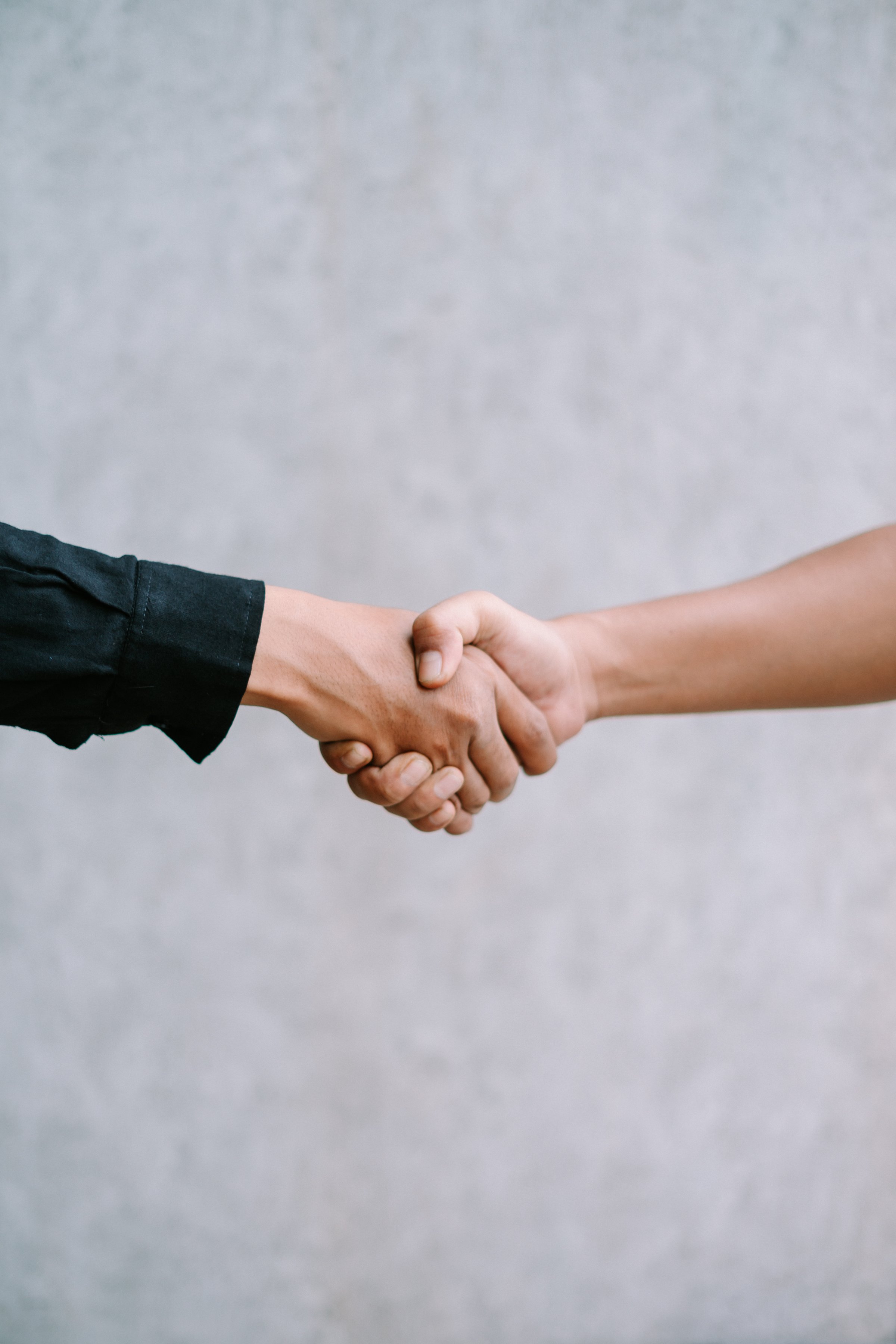 Two people shaking hands in agreement.