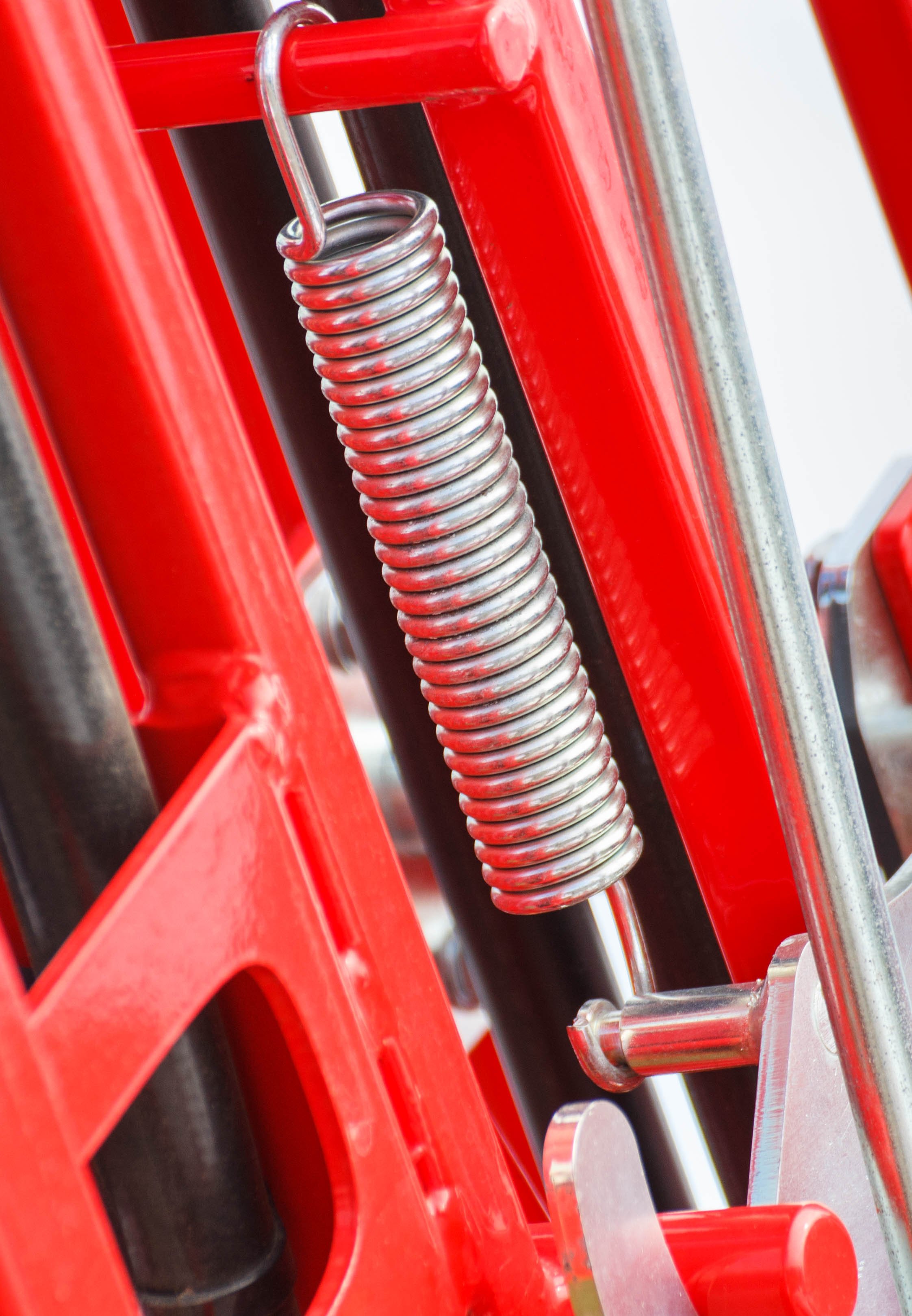 Hard spring made of steel. Part and detail of industrial or agricultural machine. Technology