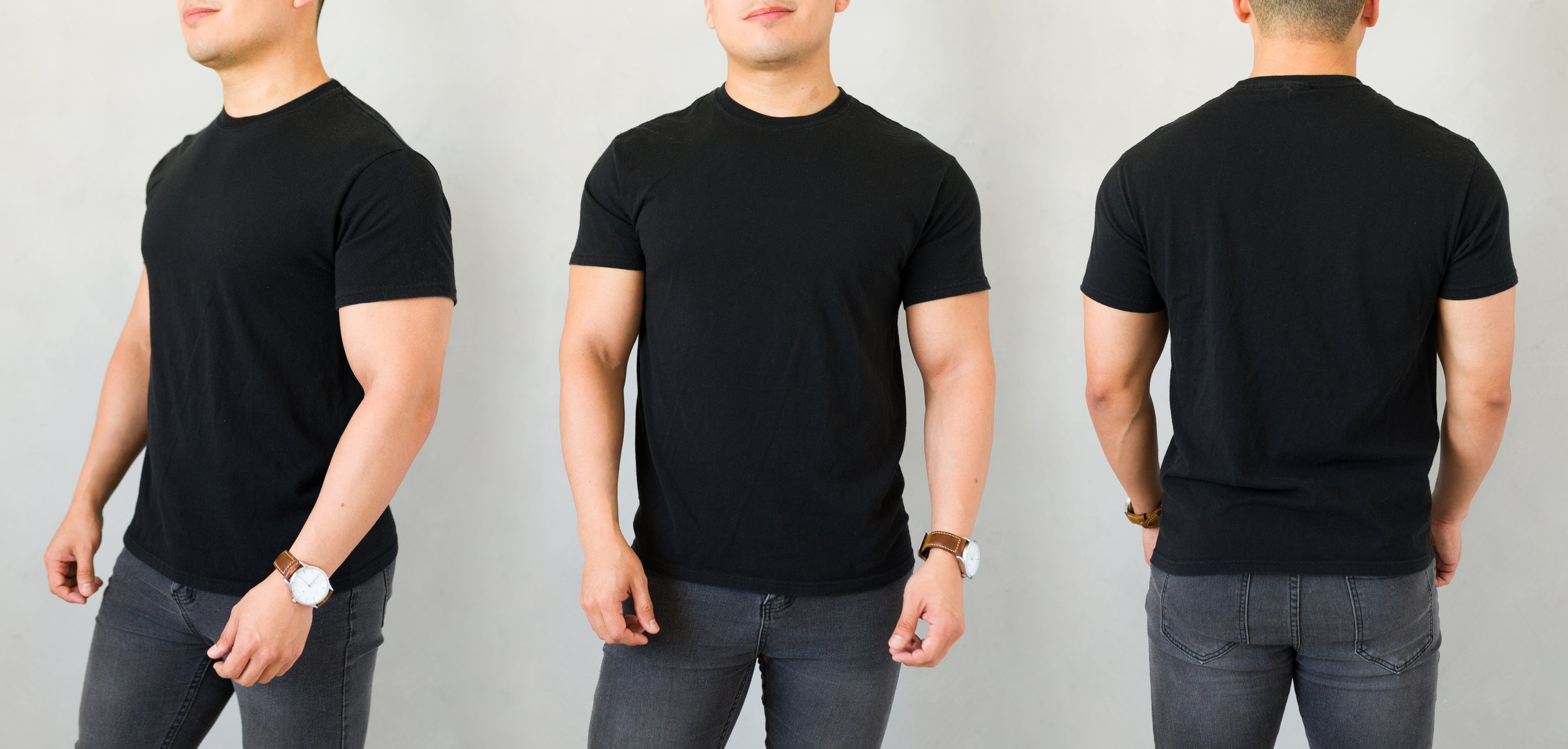 Young man is posing in front of a grey wall, wearing a black t-shirt, providing a blank canvas for your design or logo
