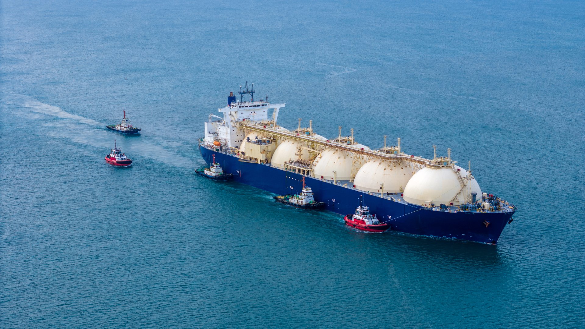 LNG (Liquified Natural Gas) tanker anchored in Gas terminal gas tanks for storage. Oil Crude Gas Tanker Ship. LPG at Tanker Bay Petroleum Chemical or Methane freighter export import transportation