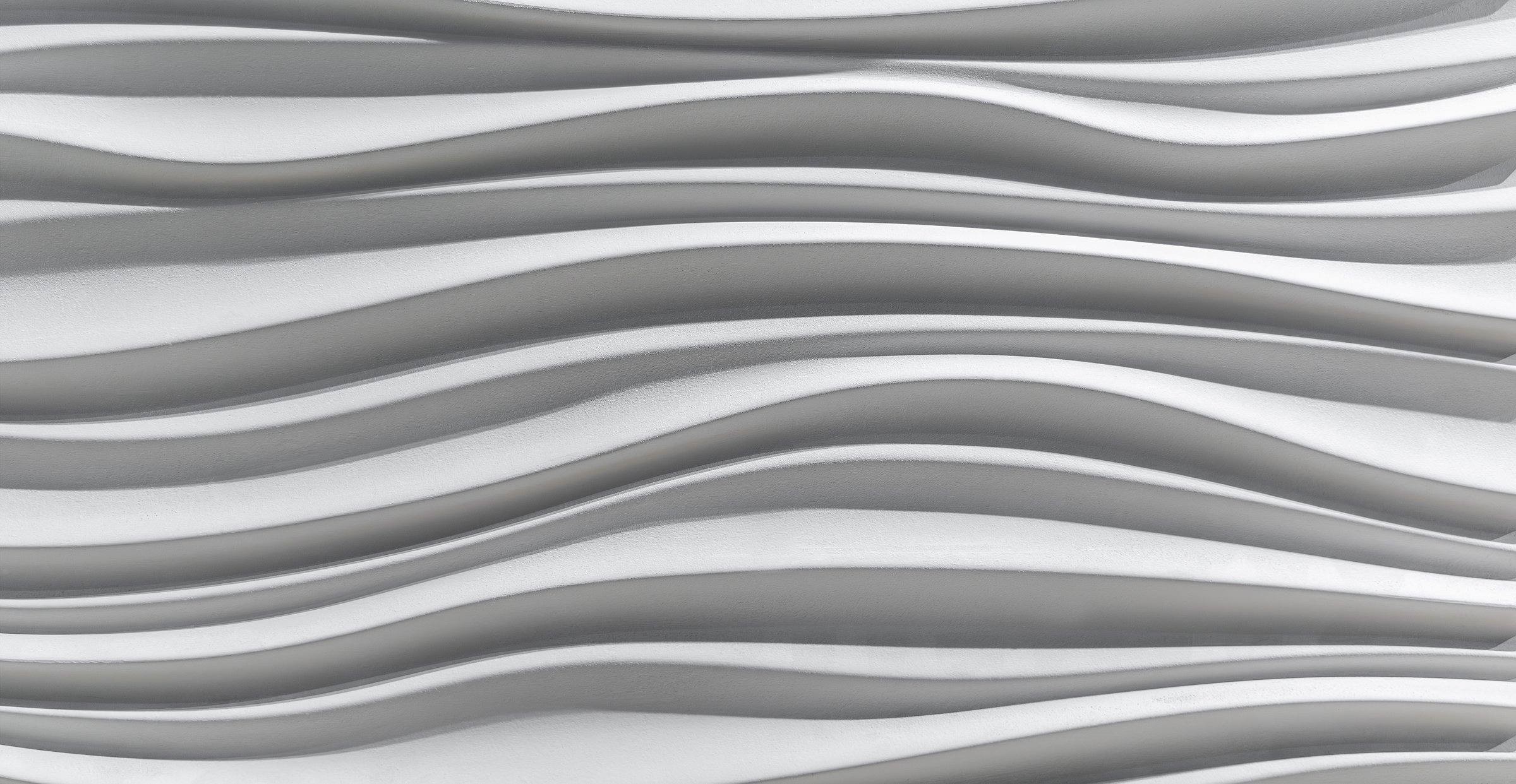White 3D wall with wave texture pattern. Curved wave-like lines in a monochrome white 3D wall texture design create a smooth, abstract pattern with shadows enhancing the sculpted flowing appearance across the surface