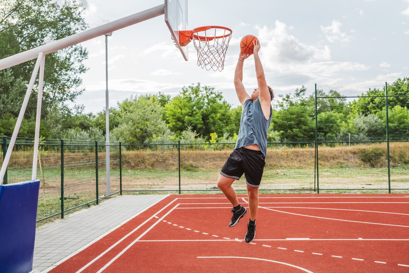 young man player, playing basketball and scoring a point on court
