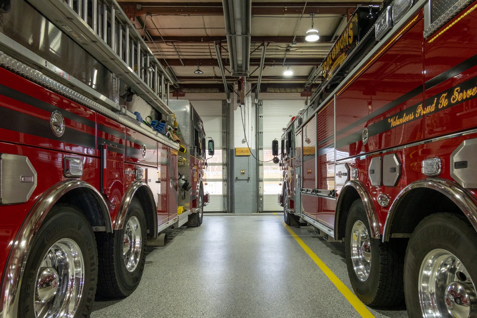 Fire trucks parked inside the local volunteer firehouse